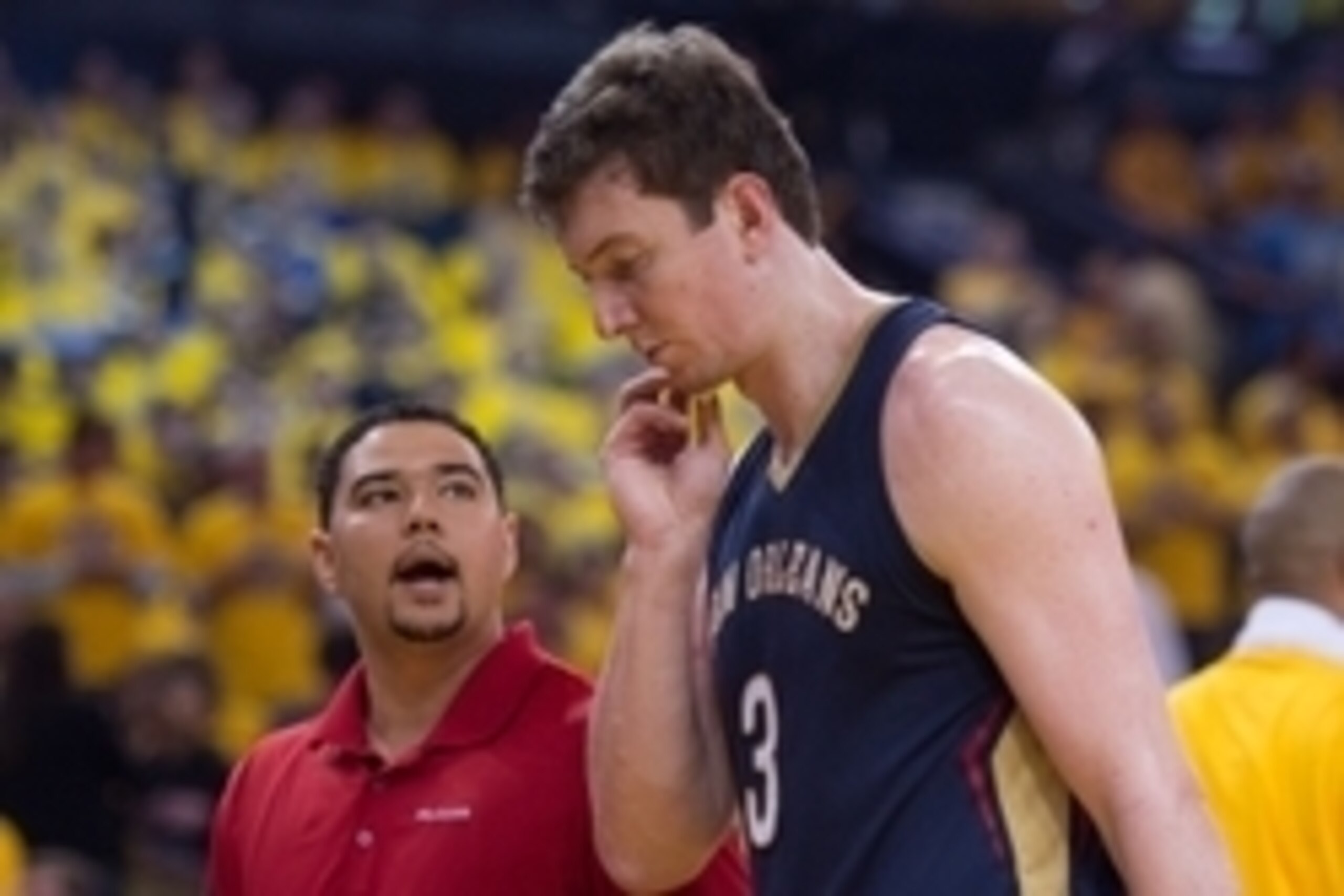 April 20, 2015; Oakland, CA, USA; New Orleans Pelicans center Omer Asik (3) walks off the court with the trainer during the second quarter in game two of the second round of the NBA Playoffs against the Golden State Warriors at Oracle Arena. Mandatory Cre