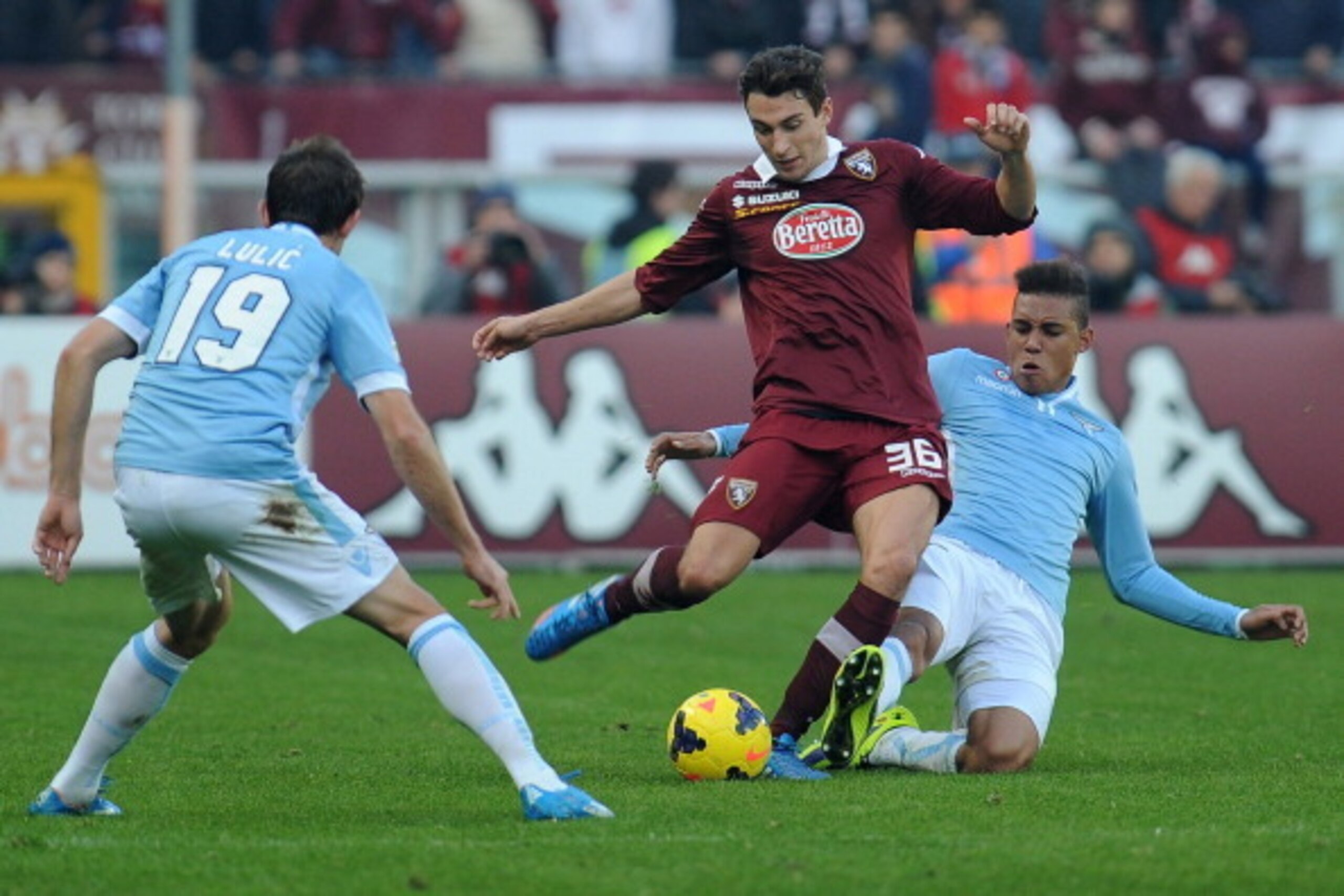 TURIN, ITALY - DECEMBER 08:  Matteo Darmian (C) of Torino FC is tackled by Brayan Perea of SS Lazio during the Serie A match between Torino FC and SS Lazio at Stadio Olimpico di Torino on December 8, 2013 in Turin, Italy.  (Photo by Valerio Pennicino/Gett