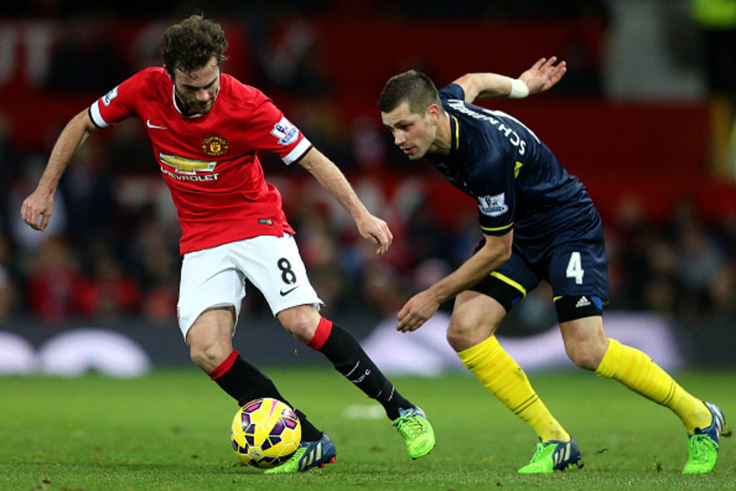 MANCHESTER, ENGLAND - JANUARY 11:  Juan Mata of Manchester United battles for the ball with Morgan Schneiderlin of Southampton during the Barclays Premier League match between Manchester United and Southampton at Old Trafford on January 11, 2015 in Manche