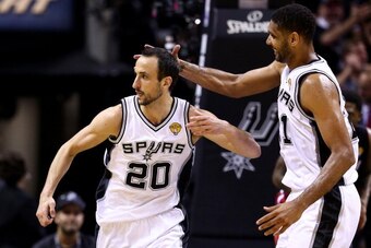 SAN ANTONIO, TX - JUNE 15: Manu Ginobili #20 celebrates with Tim Duncan #21 of the San Antonio Spurs after hitting a shot against the Miami Heat during Game Five of the 2014 NBA Finals at the AT&T Center on June 15, 2014 in San Antonio, Texas. NOTE TO USE