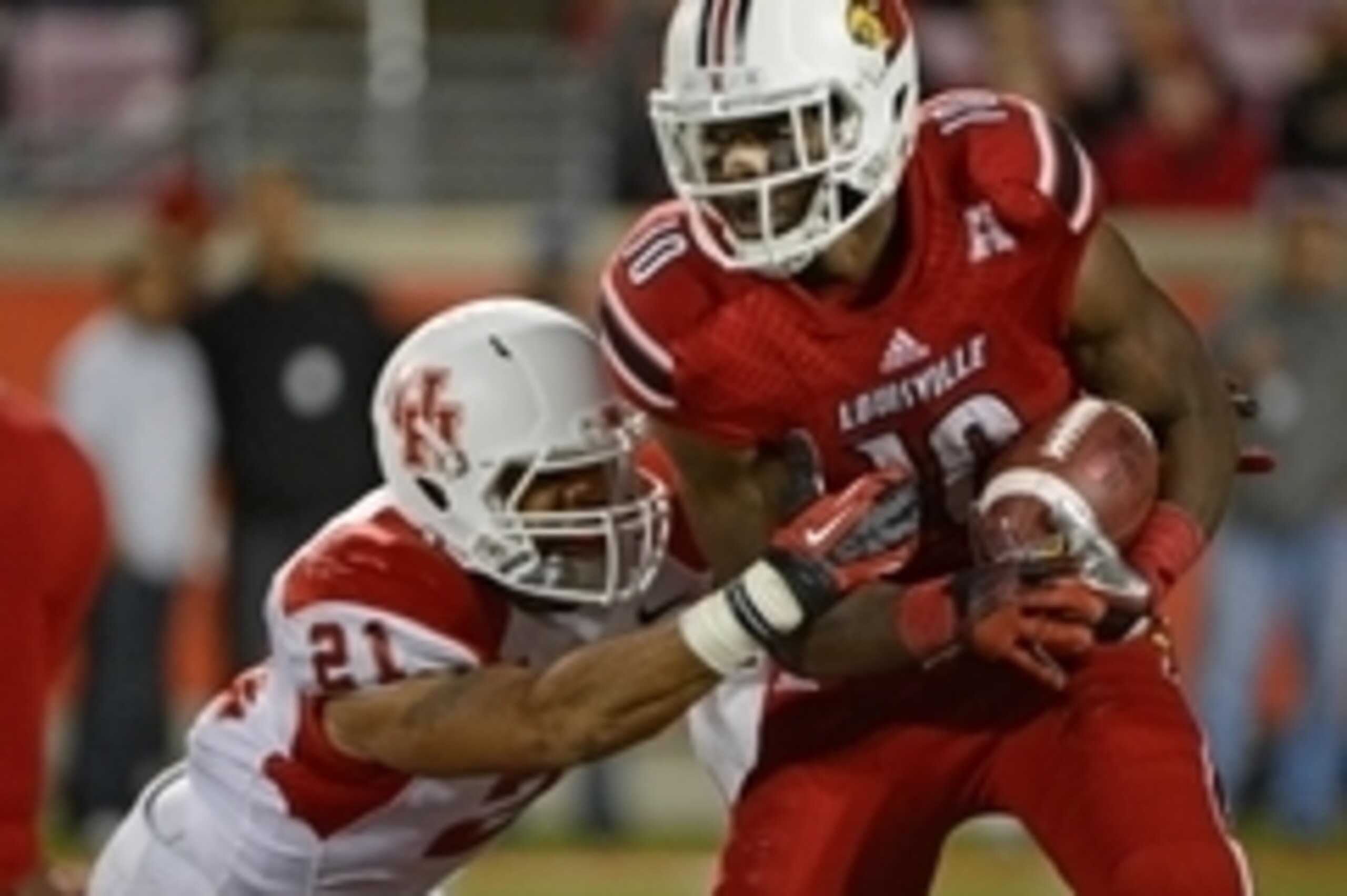 Nov 16, 2013; Louisville, KY, USA; Louisville Cardinals running back Dominique Brown (10) runs the ball against Houston Cougars defensive end Eric Eiland (21) during the second half of play at Papa John's Cardinal Stadium. Louisville defeated Houston 20-1 Nov 16, 2013; Louisville, KY, USA; Louisville Cardinals running back Dominique Brown (10) runs the ball against Houston Cougars defensive end Eric Eiland (21) during the second half of play at Papa John's Cardinal Stadium. Louisville defeated Houston 20-1