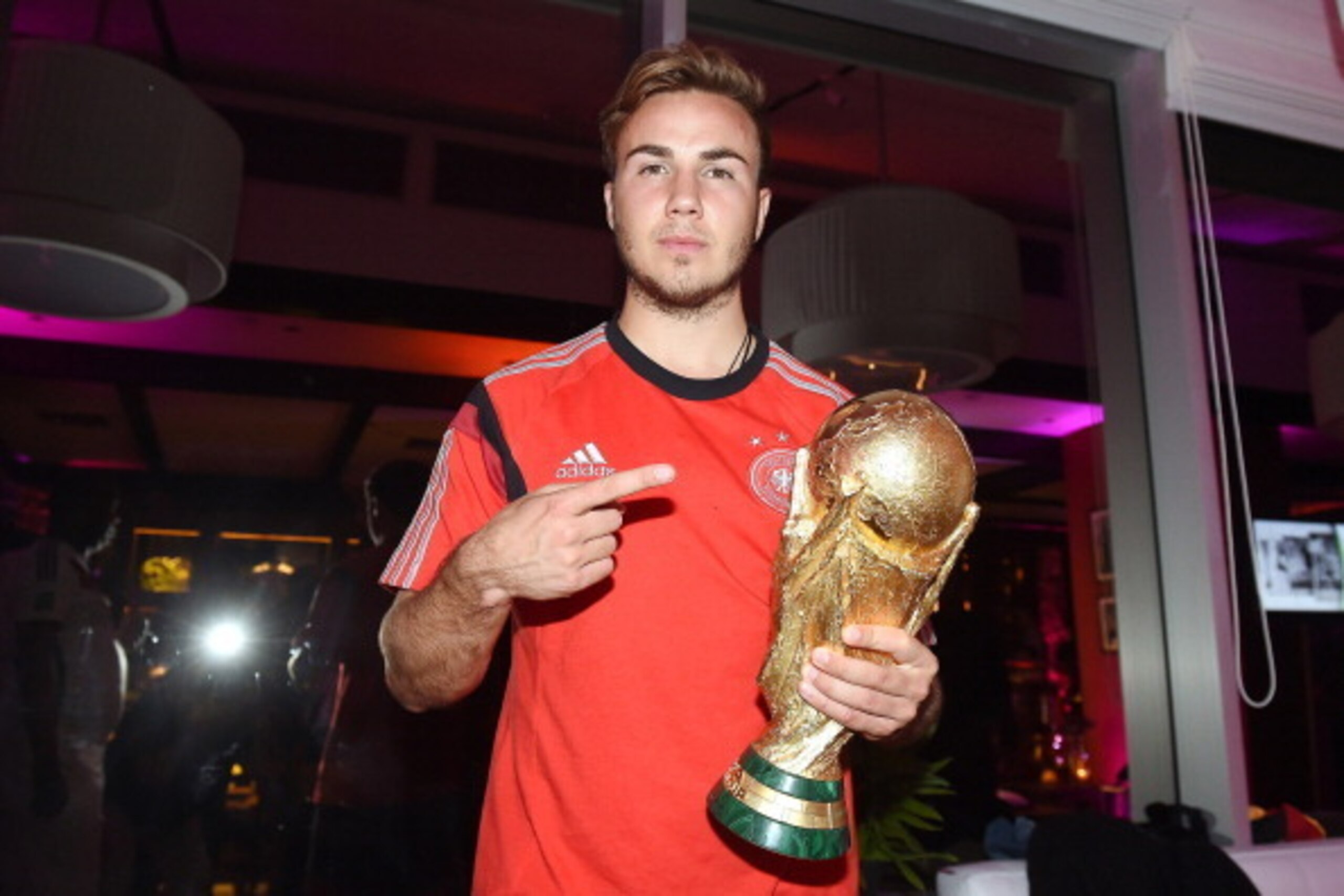 RIO DE JANEIRO, BRAZIL - JULY 13:  Goalscorer Mario Gotze of Germany poses with the World Cup trophy as he celebrates with teammates at a party, after winning the 2014 FIFA World Cup Brazil Final match against Argentina, at Sheraton Hotel on July 13, 2014
