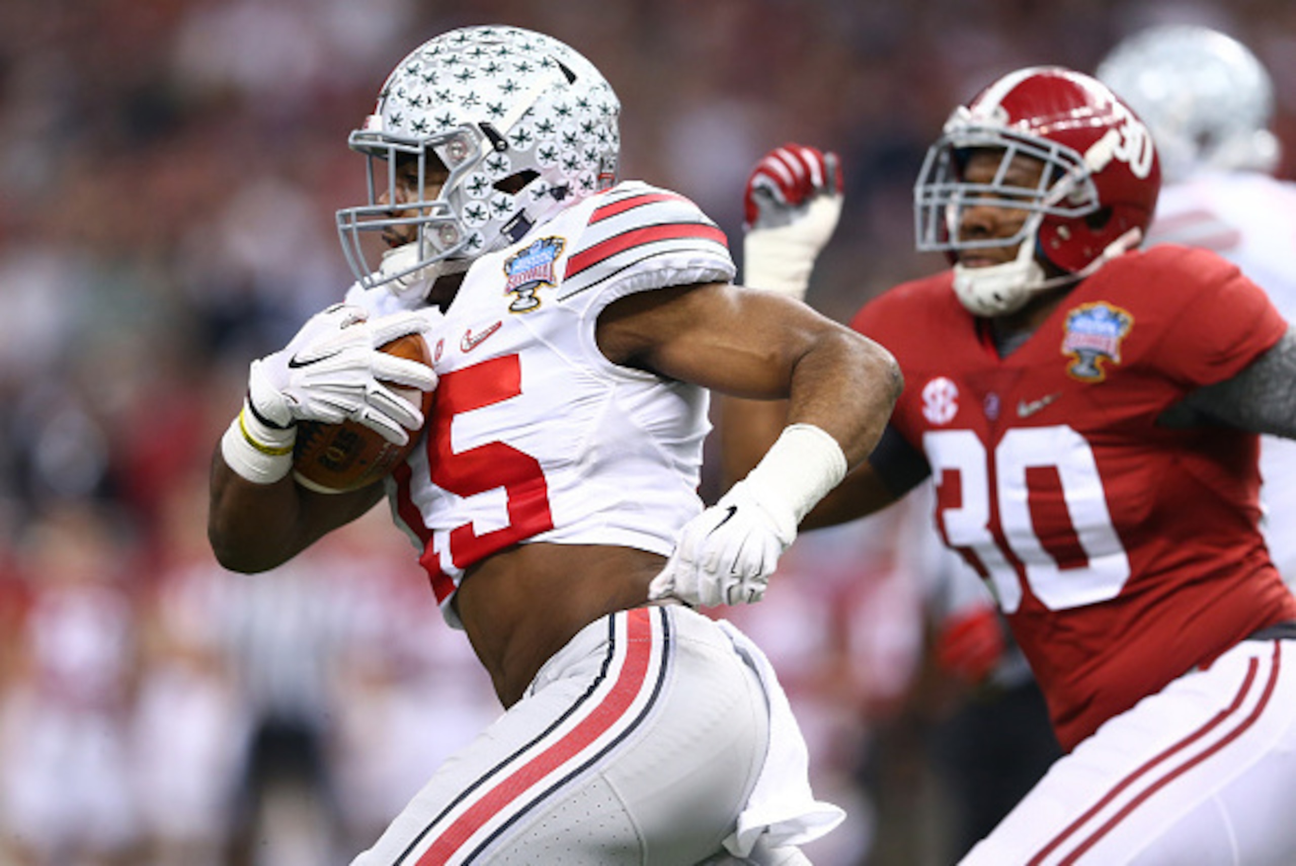 NEW ORLEANS, LA - JANUARY 01:  Ezekiel Elliott #15 of the Ohio State Buckeyes runs the ball against the Alabama Crimson Tide during the All State Sugar Bowl at the Mercedes-Benz Superdome on January 1, 2015 in New Orleans, Louisiana.  (Photo by Streeter L