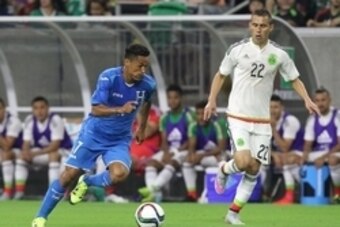 Jul 1, 2015; Houston, TX, USA; Honduras midfielder Andy Najar (17) dribbles against Mexico defender Paul Aguilar (22) in the first half during a soccer match at NRG Stadium. The game ended in a draw 0 to 0 .Mandatory Credit: Thomas B. Shea-USA TODAY Sport