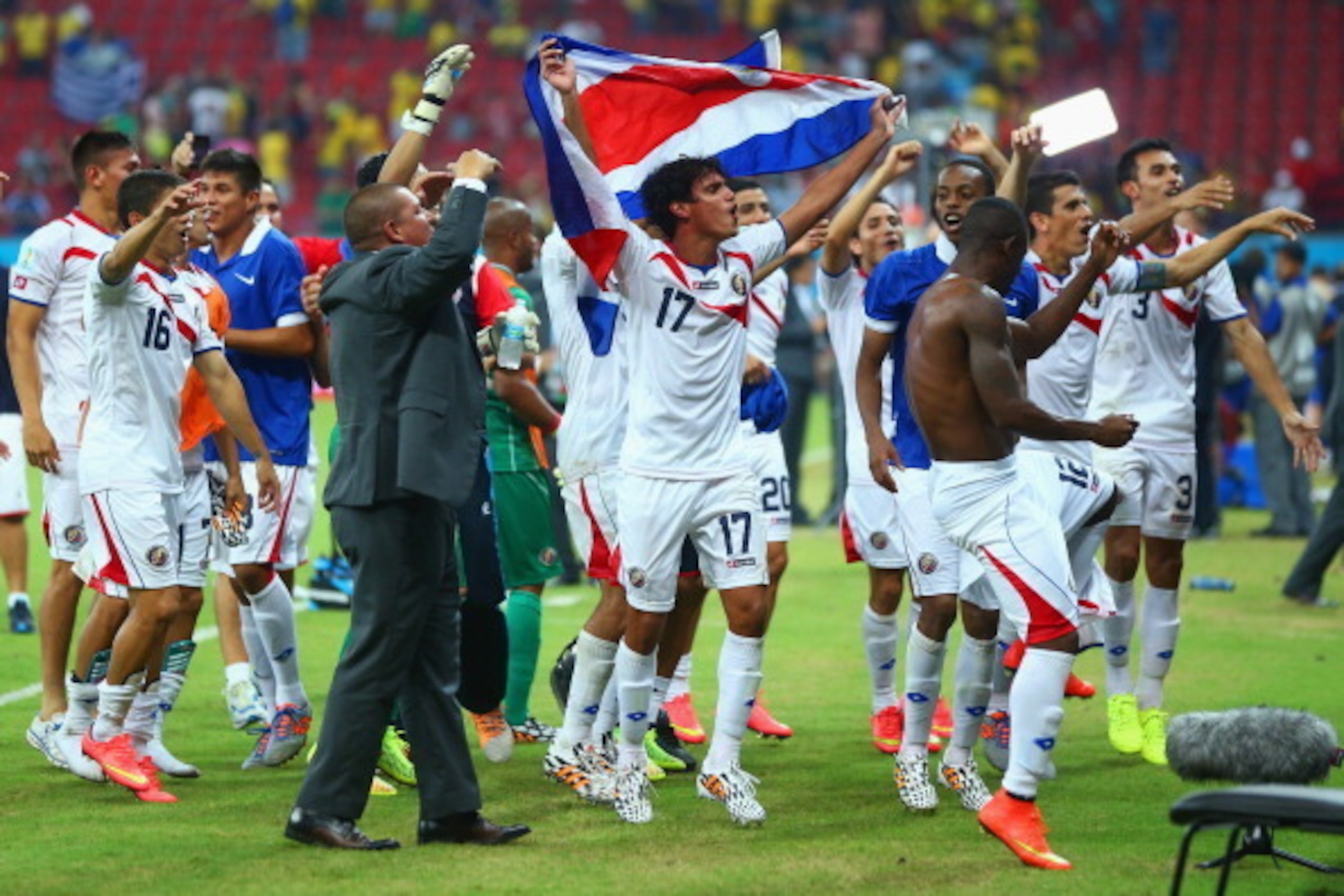 RECIFE, BRAZIL - JUNE 29: Yeltsin Tejeda of Costa Rica holds up his countries flag in celebration with his teammates after defeating Greece in a penalty shootout during the 2014 FIFA World Cup Brazil Round of 16 match between Costa Rica and Greece at Aren RECIFE, BRAZIL - JUNE 29: Yeltsin Tejeda of Costa Rica holds up his countries flag in celebration with his teammates after defeating Greece in a penalty shootout during the 2014 FIFA World Cup Brazil Round of 16 match between Costa Rica and Greece at Aren