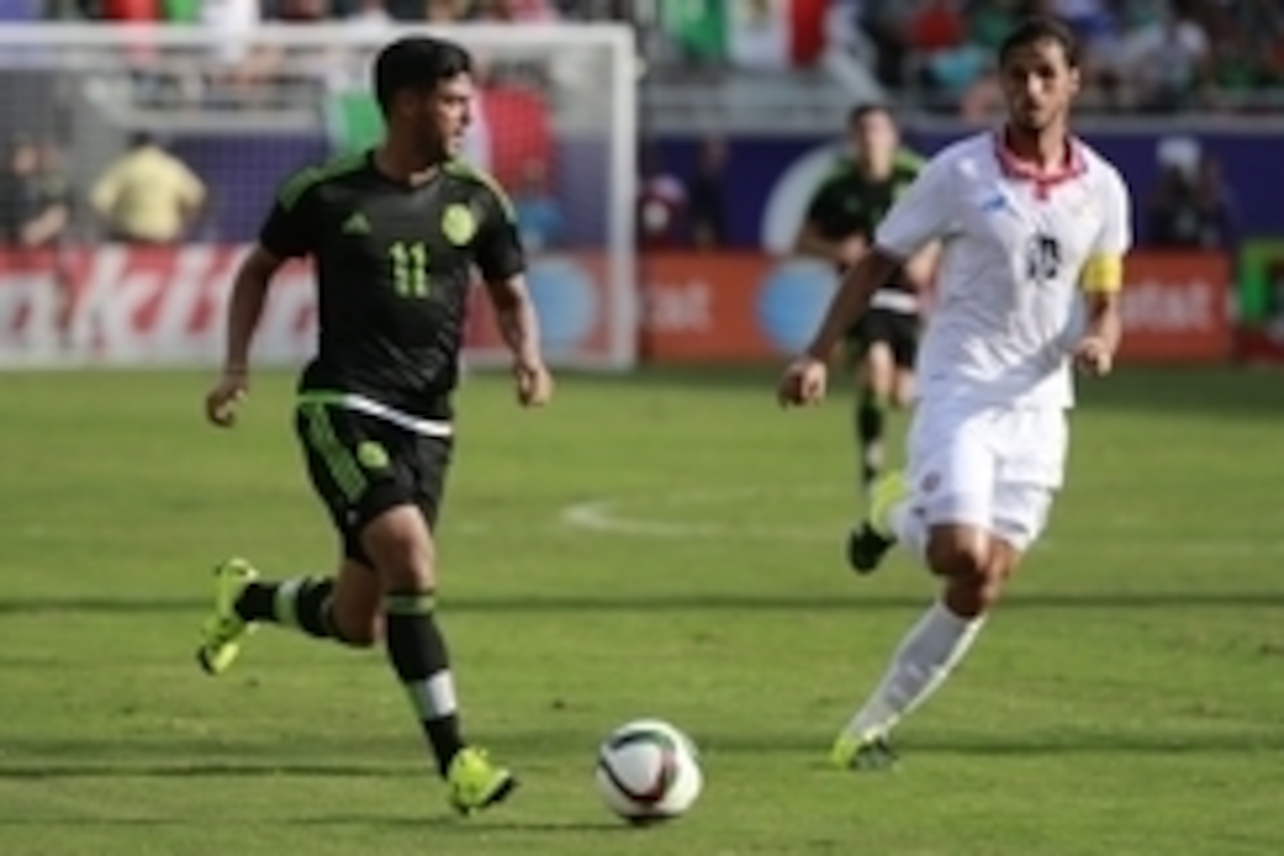Jun 27, 2015; Orlando, FL, USA; Mexico forward Carlos Vela (11) dribbles the ball as Costa Rica forward Bryan Ruiz (10) defends during the first half at Orlando Citrus Bowl. Mandatory Credit: Kim Klement-USA TODAY Sports