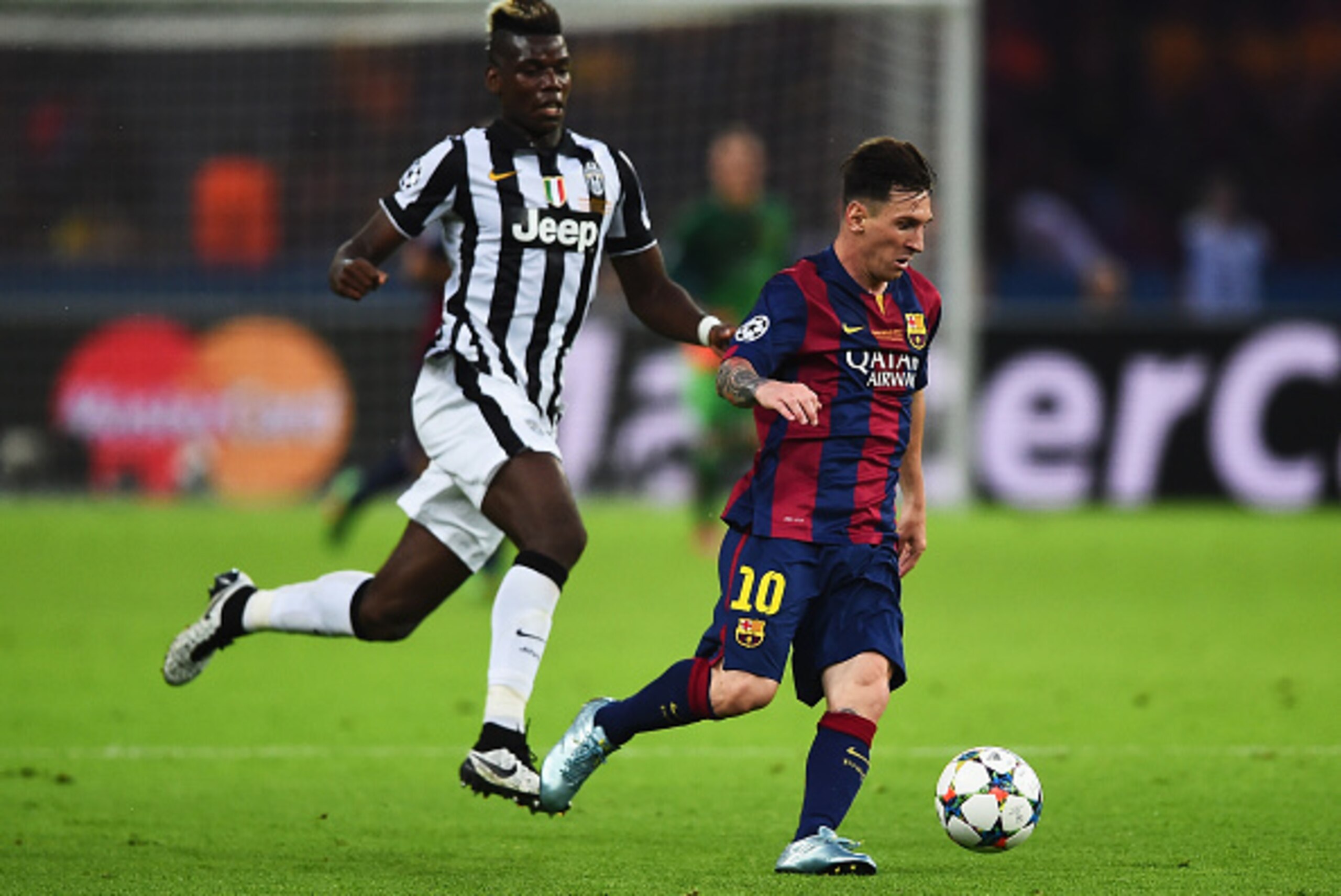 BERLIN, GERMANY - JUNE 06: Lionel Messi of Barcelona goes past Paul Pogba of Juventus during the UEFA Champions League Final between Juventus and FC Barcelona at Olympiastadion on June 6, 2015 in Berlin, Germany.  (Photo by Laurence Griffiths/Getty Images