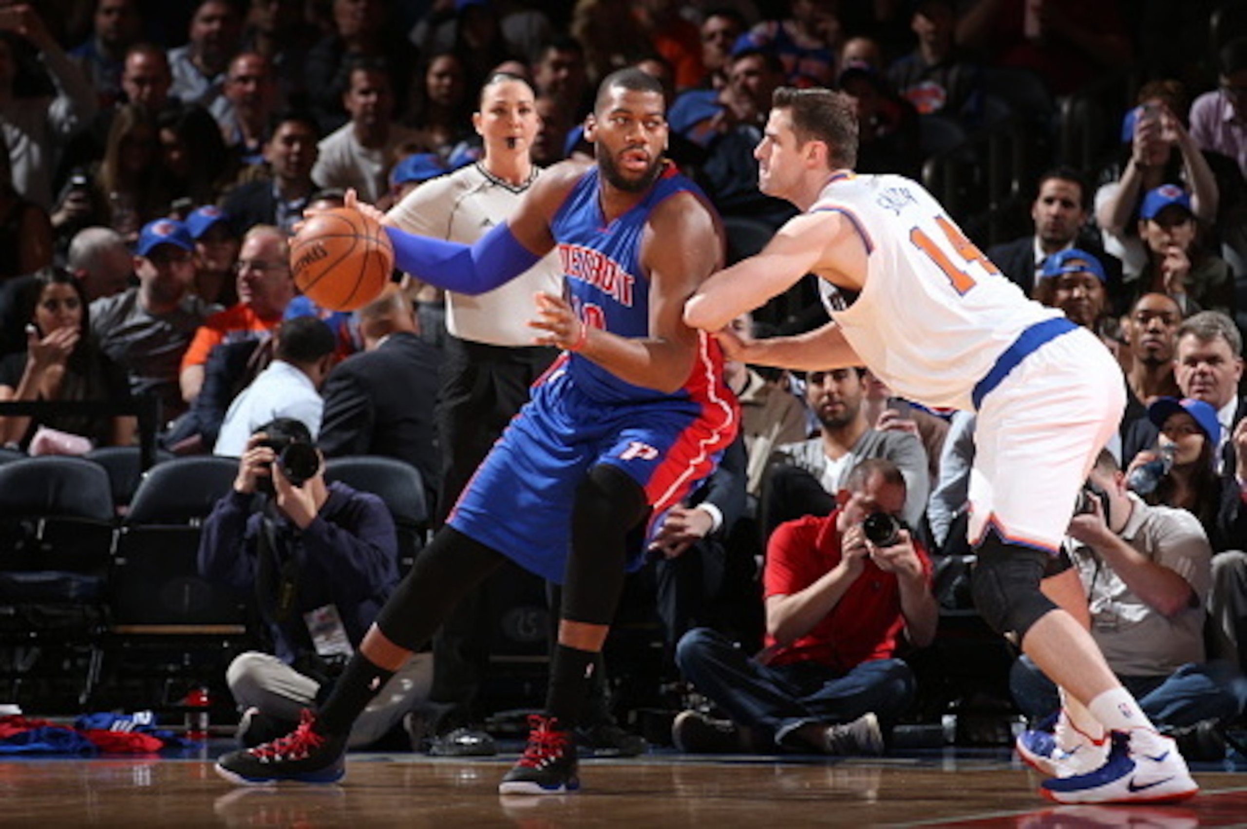 NEW YORK, NY - APRIL 15:  Greg Monroe #10 of the Detroit Pistons handles the ball against Jason Smith #14 of the New York Knicks on April 15, 2015 at Madison Square Garden in New York City.  NOTE TO USER: User expressly acknowledges and agrees that, by do