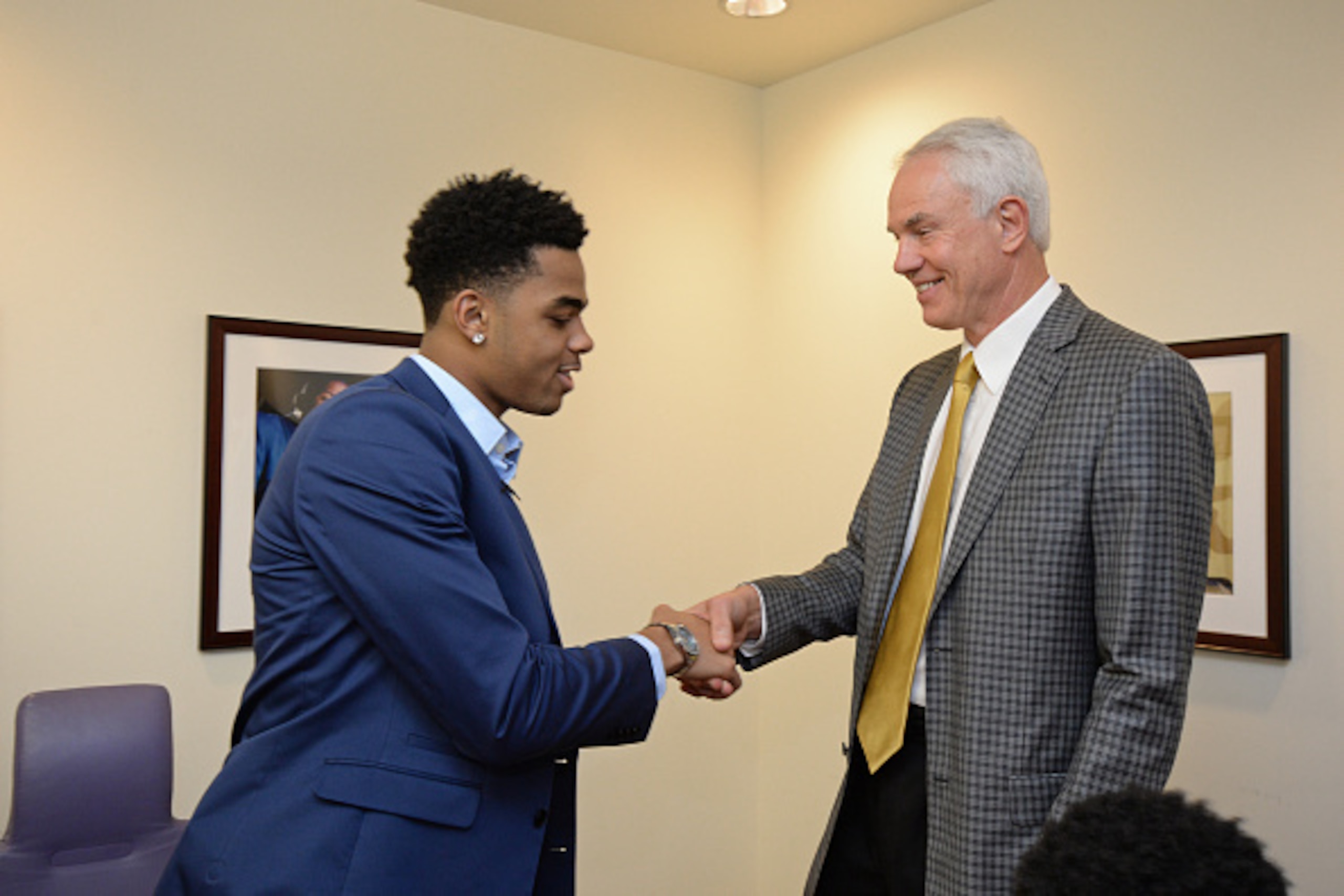EL SEGUNDO, CA - JUNE 29: D'Angelo Russell #1 of the Los Angeles Lakers shakes hands with General Manager Mitch Kupchak before they attend a press conference at Toyota Sports Center on June 29, 2015 in El Segundo California. NOTE TO USER: User expressly EL SEGUNDO, CA - JUNE 29: D'Angelo Russell #1 of the Los Angeles Lakers shakes hands with General Manager Mitch Kupchak before they attend a press conference at Toyota Sports Center on June 29, 2015 in El Segundo California. NOTE TO USER: User expressly