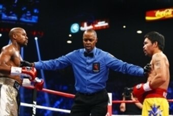 May 2, 2015; Las Vegas, NV, USA; Referee Kenny Bayless (center) separates Manny Pacquiao (right) from Floyd Mayweather during their boxing bout at the MGM Grand Garden Arena. Mandatory Credit: Mark J. Rebilas-USA TODAY Sports