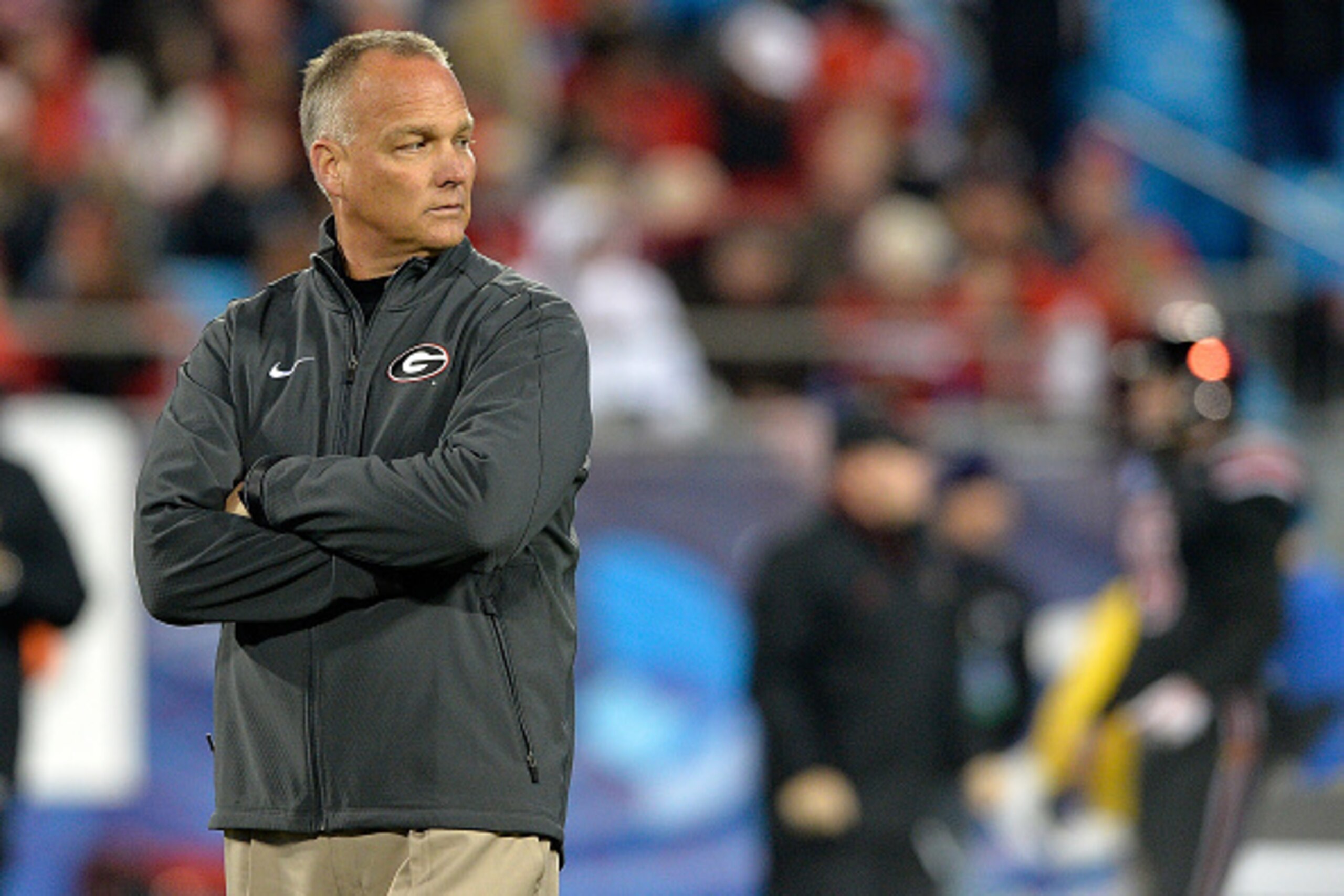 CHARLOTTE, NC - DECEMBER 30:  Head coach Mark Richt of the Georgia Bulldogs  watches his team warm up before a game against the Louisville Cardinals during the Belk Bowl at Bank of America Stadium on December 30, 2014 in Charlotte, North Carolina.  (Photo