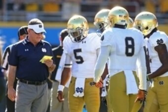 Nov 8, 2014; Tempe, AZ, USA; Notre Dame Fighting Irish head coach Brian Kelly (left) talks to quarterback Everett Golson (5) against the Arizona State Sun Devils at Sun Devil Stadium. Arizona State defeated Notre Dame 55-31. Mandatory Credit: Mark J. Rebi