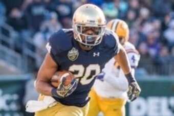 Dec 30, 2014; Nashville, TN, USA; Notre Dame Fighting Irish wide receiver C.J. Prosise (20) carries the ball in the first quarter against the Louisiana State Tigers at LP Field. Notre Dame won 31-28. Mandatory Credit: Matt Cashore-USA TODAY Sports