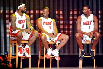 MIAMI - JULY 09:   LeBron James #6, Dwyane Wade #3 and Chris Bosh #1 of the Miami Heat speak after being introduced to fans during a welcome party at American Airlines Arena on July 9, 2010 in Miami, Florida.  (Photo by Doug Benc/Getty Images)