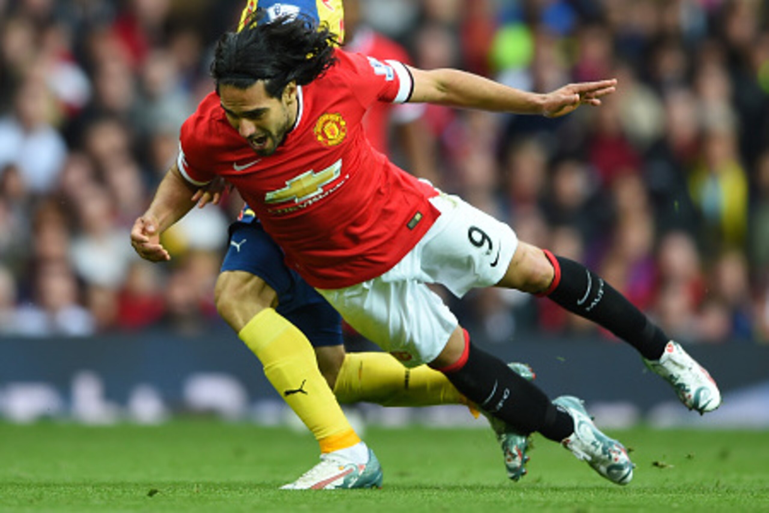 MANCHESTER, ENGLAND - MAY 17:  Radamel Falcao Garcia of Manchester United is challenged by Nacho Monreal of Arsenal during the Barclays Premier League match between Manchester United and Arsenal at Old Trafford on May 17, 2015 in Manchester, England.  (Ph