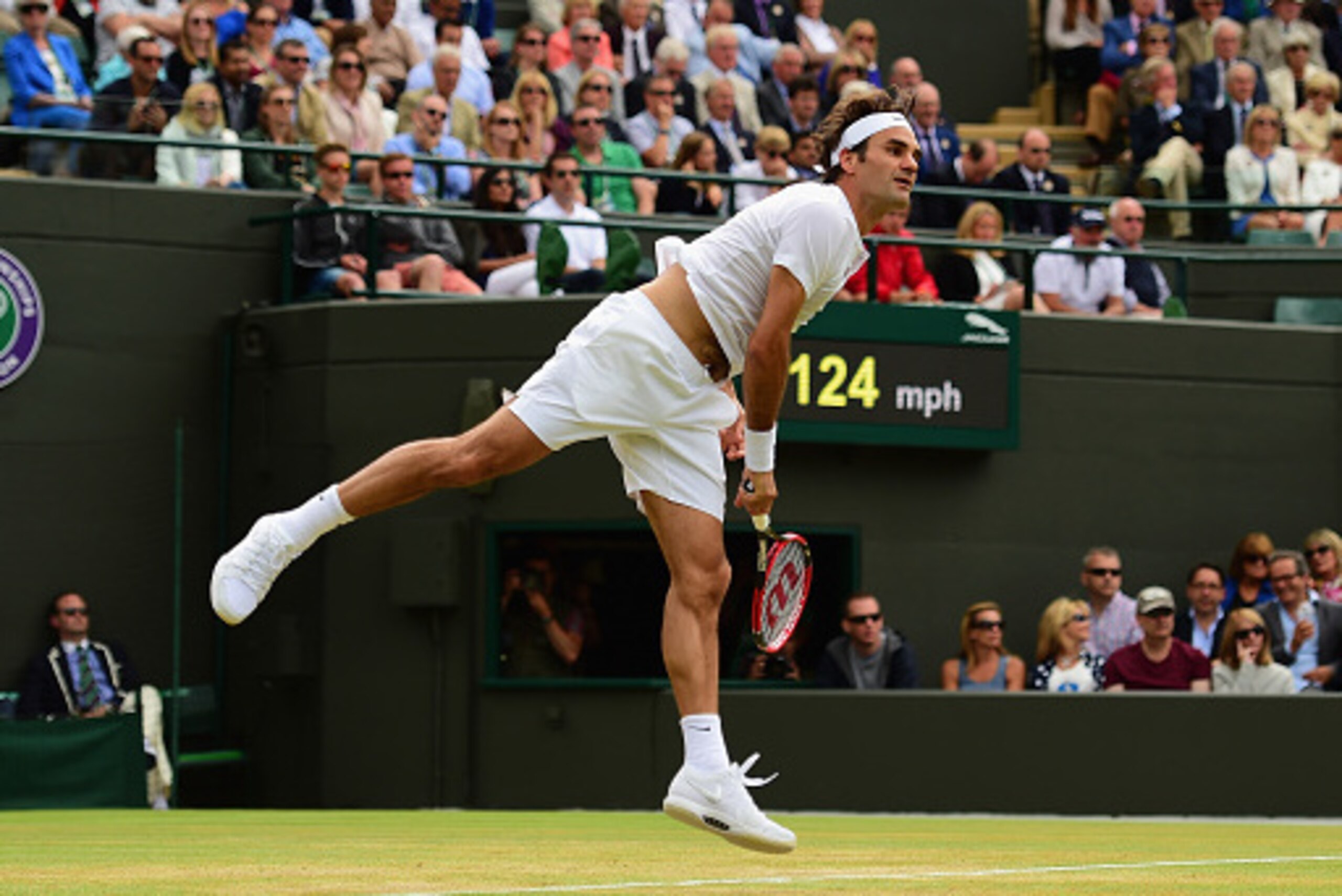 LONDON, ENGLAND - JULY 08:  Roger Federer of Switzerland serves in his Gentlemens Singles Quarter Final match against Gilles Simon of France during day nine of the Wimbledon Lawn Tennis Championships at the All England Lawn Tennis and Croquet Club on July