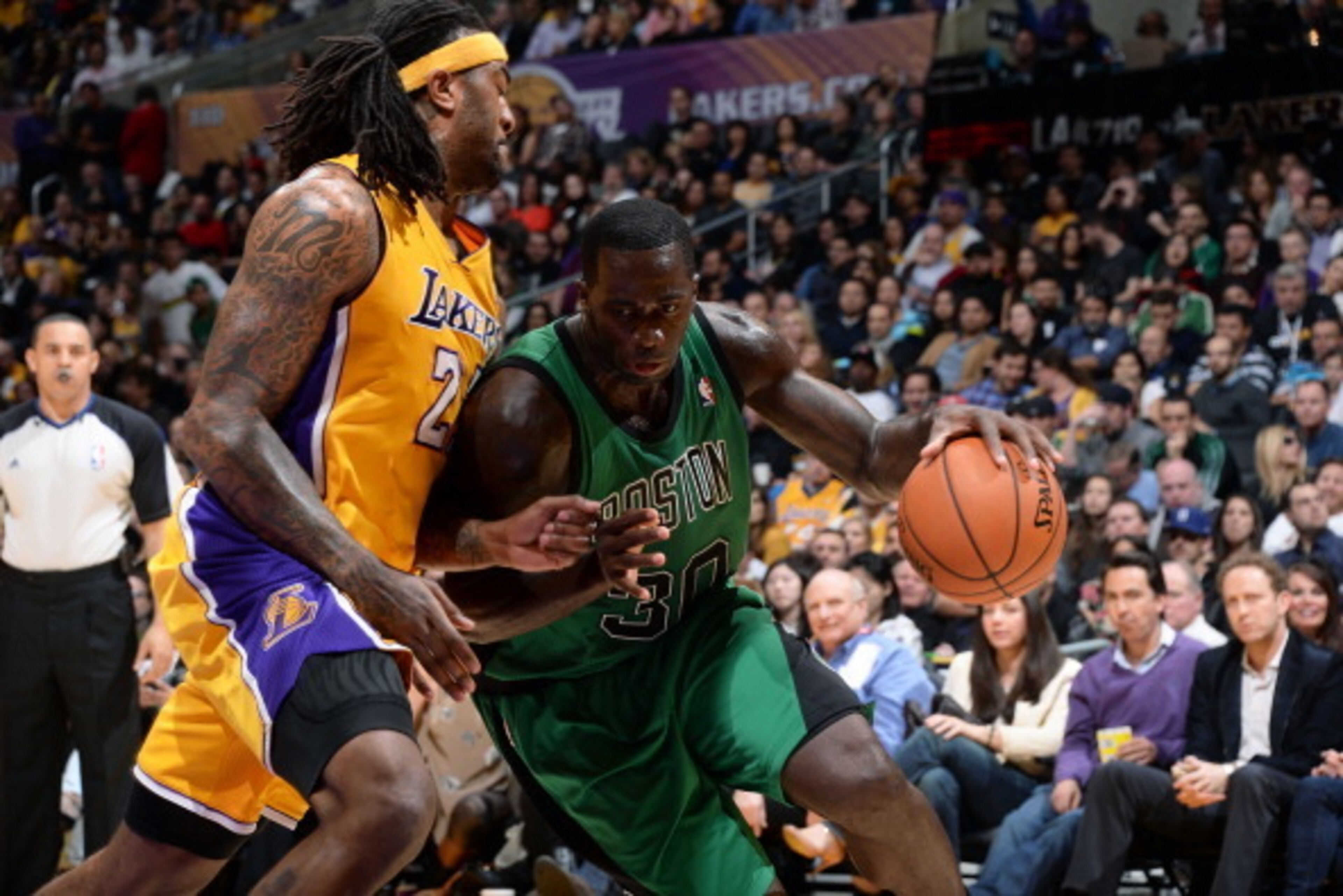 LOS ANGELES, CA - FEBRUARY 21: Brandon Bass #30 of the Boston Celtics drives to the basket against Jordan Hill #27 of the Los Angeles Lakers at STAPLES Center on February 21, 2014 in Los Angeles, California. NOTE TO USER: User expressly acknowledges and a