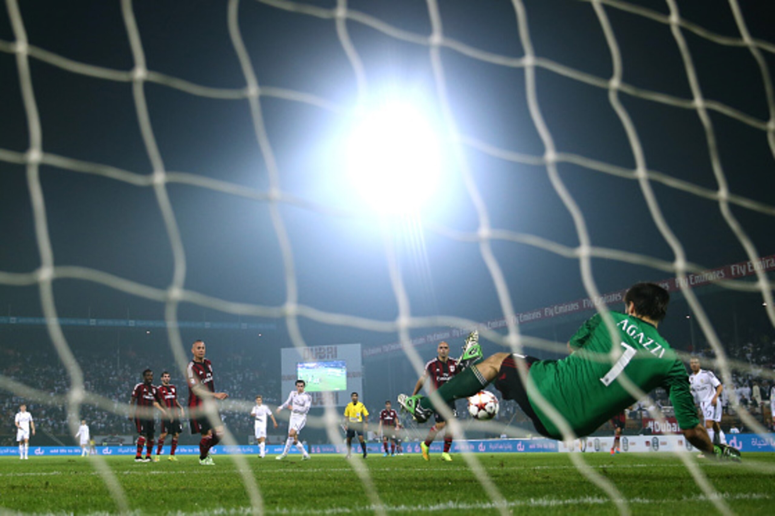 DUBAI, UNITED ARAB EMIRATES - DECEMBER 30: Gareth Bale of Real Madrid strikes at goal, saved by Michael Agazzi of AC Milan during the Dubai Football Challenge match between AC Milan and Real Madrid at The Sevens Stadium on December 30, 2014 in Dubai, Uni DUBAI, UNITED ARAB EMIRATES - DECEMBER 30: Gareth Bale of Real Madrid strikes at goal, saved by Michael Agazzi of AC Milan during the Dubai Football Challenge match between AC Milan and Real Madrid at The Sevens Stadium on December 30, 2014 in Dubai, Uni