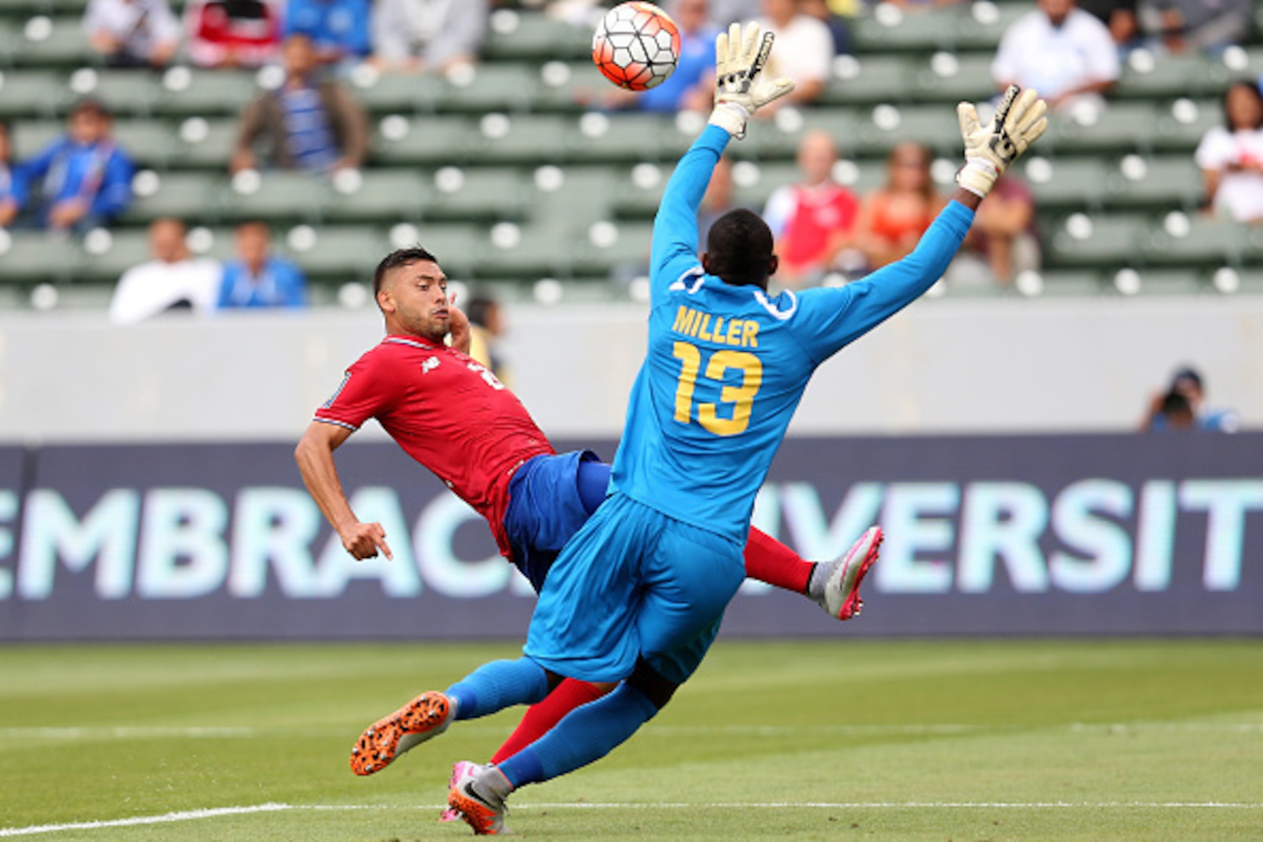 LOS ANGELES, CA - JULY 08: David Ramirez #21 of Costa Rica gets the ball over goalkeeper Dwayne Miller #13 of Jamaica to score a goal in the first half of their CONCACAF Gold Cup Group B match at StubHub Center on July 8, 2015 in Los Angeles, California. 