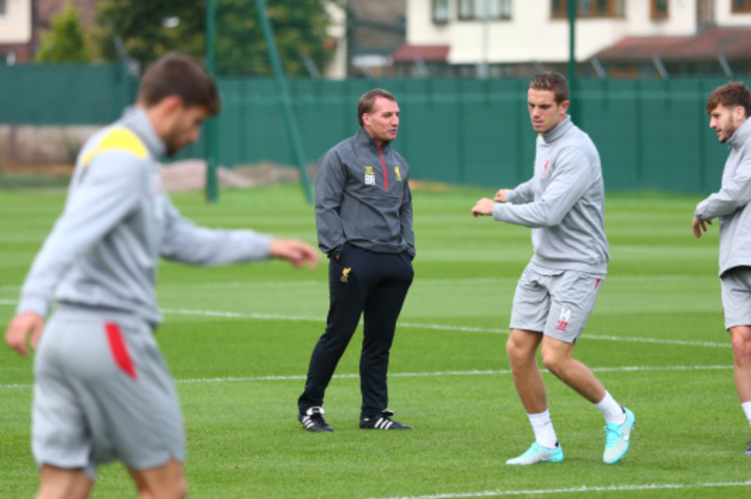LIVERPOOL, ENGLAND - SEPTEMBER 15:  Liverpool manager Brendan Rodgers keeps a close eyeon Jordan Henderson and Adam Lallana during a training session ahead of their UEFA Champions League group B match against PFC Ludogorets on September 15, 2014 in Liverp