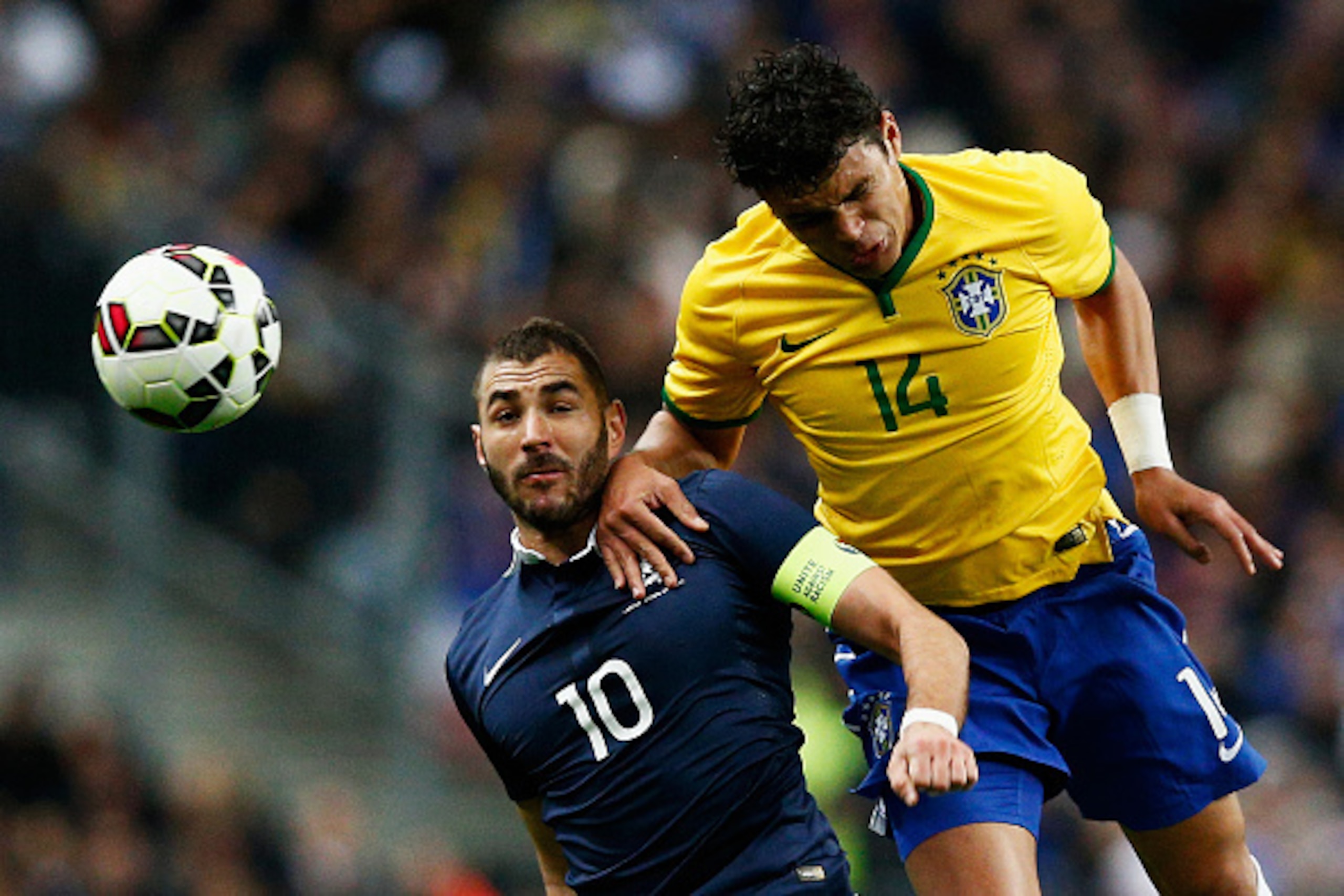 PARIS, FRANCE - MARCH 26:  Karim Benzema of France and Thiago Silva of Brazil battle for the header during the International Friendly match between France and Brazil at the Stade de France on March 26, 2015 in Paris, France.  (Photo by Dean Mouhtaropoulos