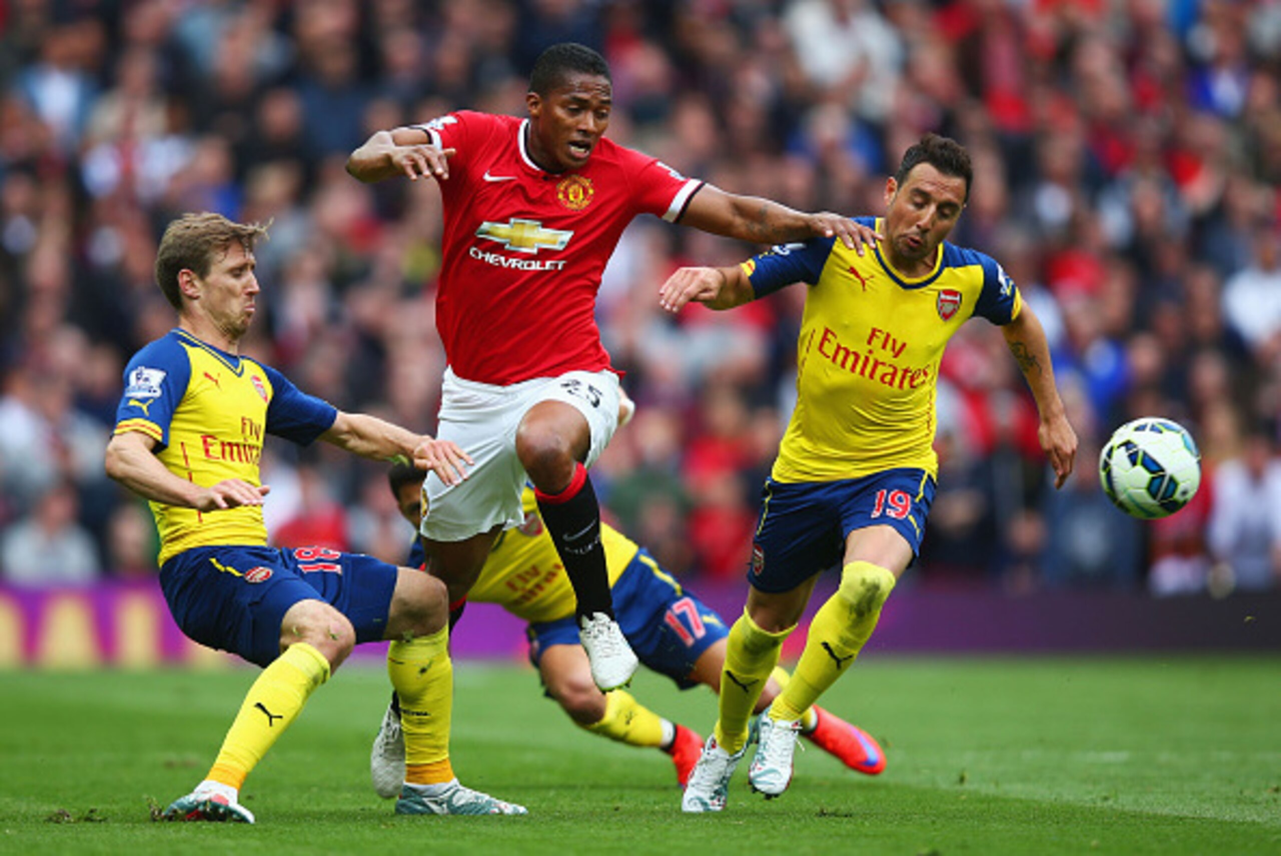 MANCHESTER, ENGLAND - MAY 17:  Luis Antonio Valencia of Manchester United takes on Nacho Monreal, Alexis Sanchez and Santi Cazorla of Arsenal during the Barclays Premier League match between Manchester United and Arsenal at Old Trafford on May 17, 2015 in