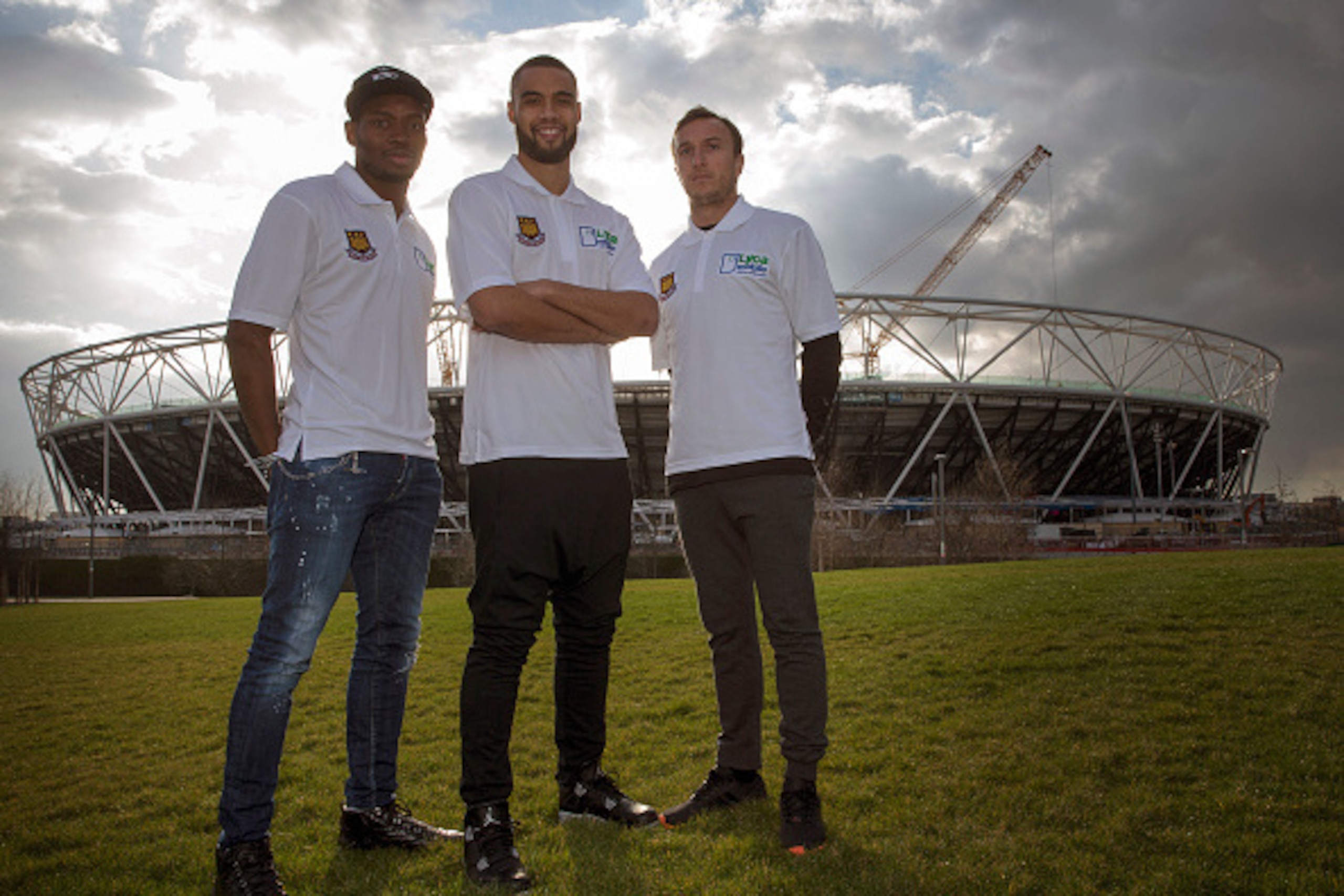 LONDON, ENGLAND - MARCH 24:  West Ham United players  Diafra Sakho, Winston Reid and Mark Noble poses for photographers outside the olympic stadium during a Lycamobile & West Ham United Partnership Announcement on March 24, 2015 in London, England.  (Phot