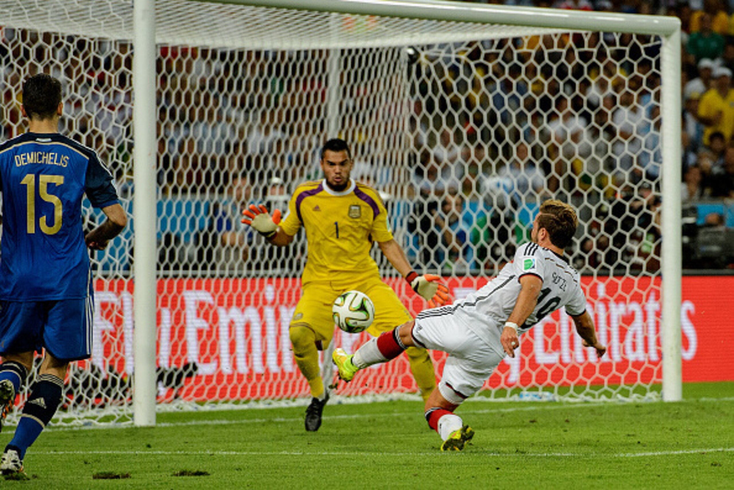 RIO DE JANEIRO, BRAZIL - JULY 13:  Mario Goetze of Germany scores his team's first goal past Sergio Romero of Argentina in extra time during the 2014 FIFA World Cup Brazil Final match between Germany and Argentina at Maracana on July 13, 2014 in Rio de Ja