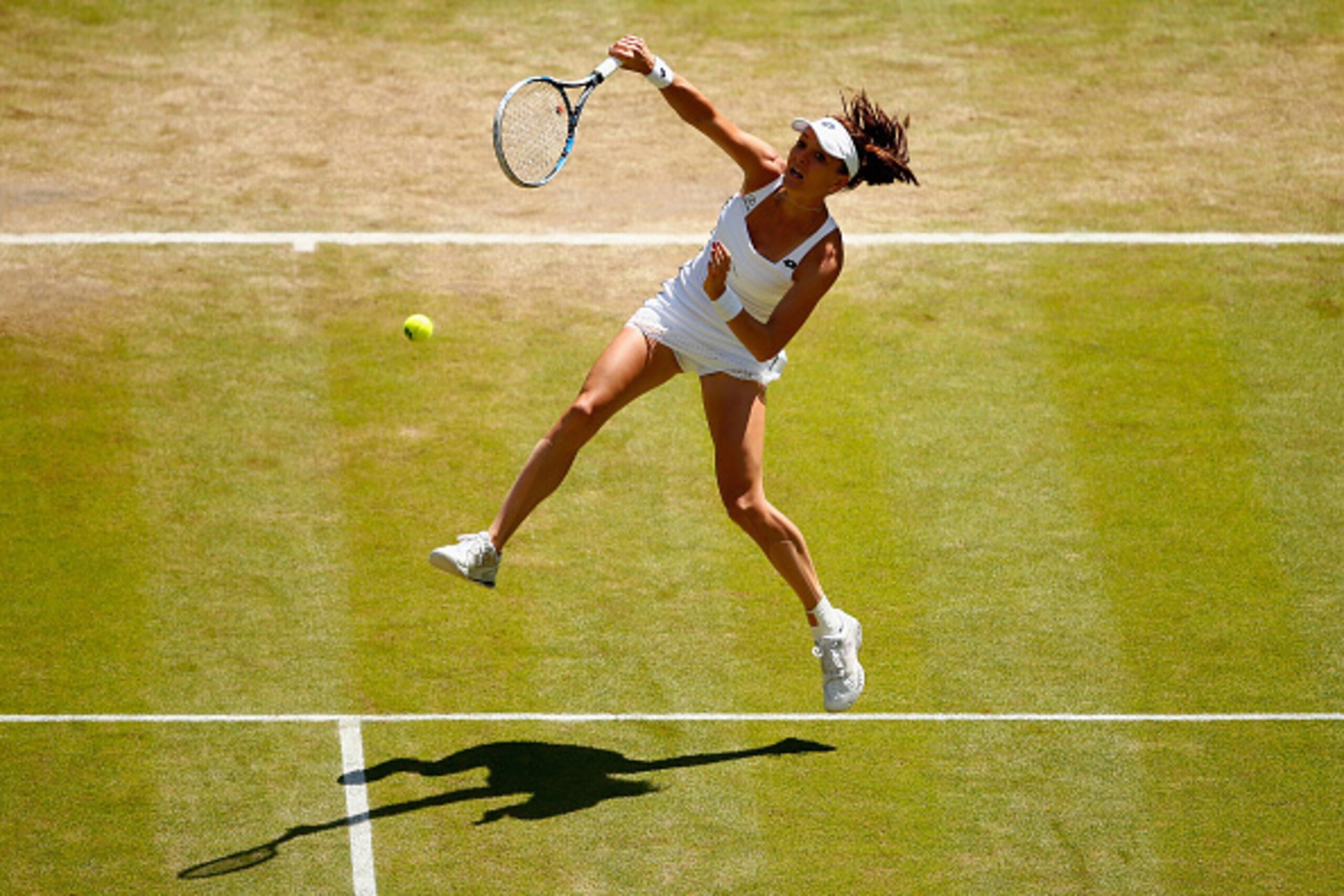 LONDON, ENGLAND - JULY 09:  Agnieszka Radwanska of Poland plays an overhead in the Ladies Singles Semi Final match against Garbine Muguruza of Spain during day ten of the Wimbledon Lawn Tennis Championships at the All England Lawn Tennis and Croquet Club 