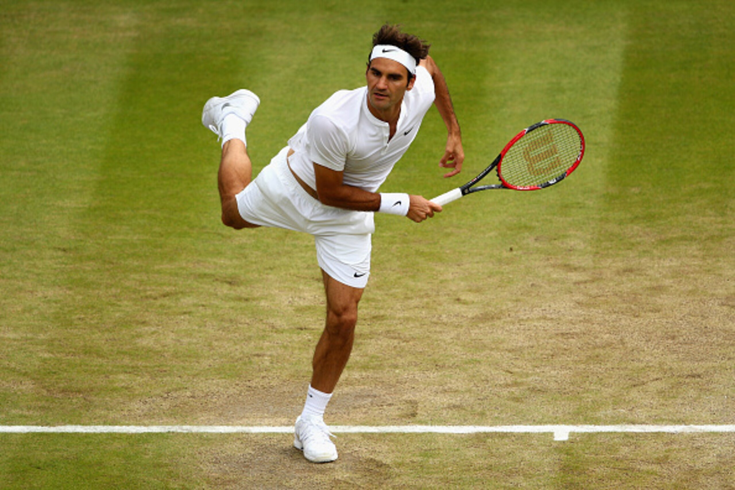 LONDON, ENGLAND - JULY 08:  Roger Federer of Switzerland serves in his Gentlemens Singles Quarter Final match against Gilles Simon of France during day nine of the Wimbledon Lawn Tennis Championships at the All England Lawn Tennis and Croquet Club on July