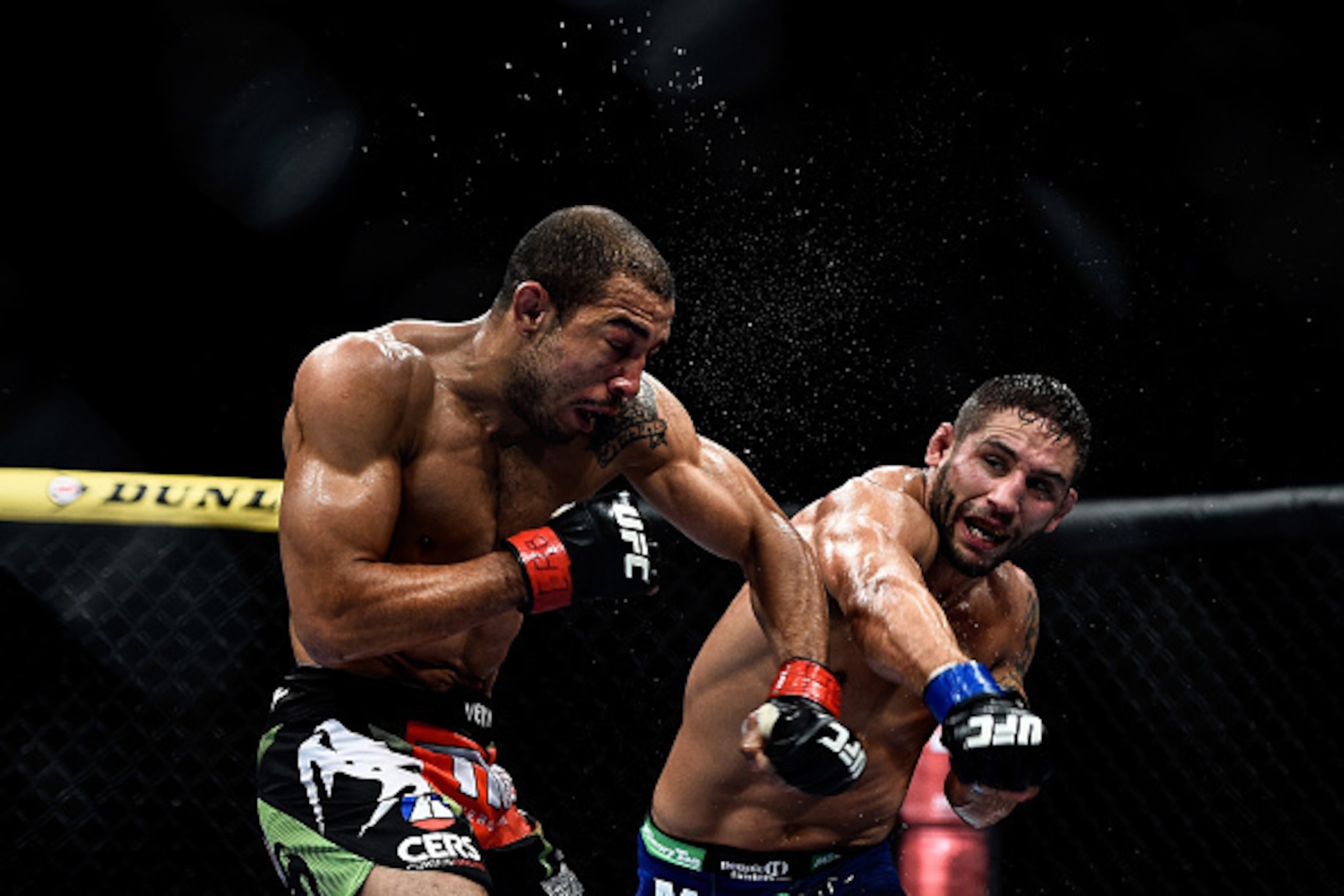RIO DE JANEIRO, BRAZIL - OCTOBER 25: Chad Mendes of the United States punches Jose Aldo of Brazil in their featherweight championship bout during the UFC 179 event at Maracanazinho on October 25, 2014 in Rio de Janeiro, Brazil. (Photo by Buda Mendes/Getty