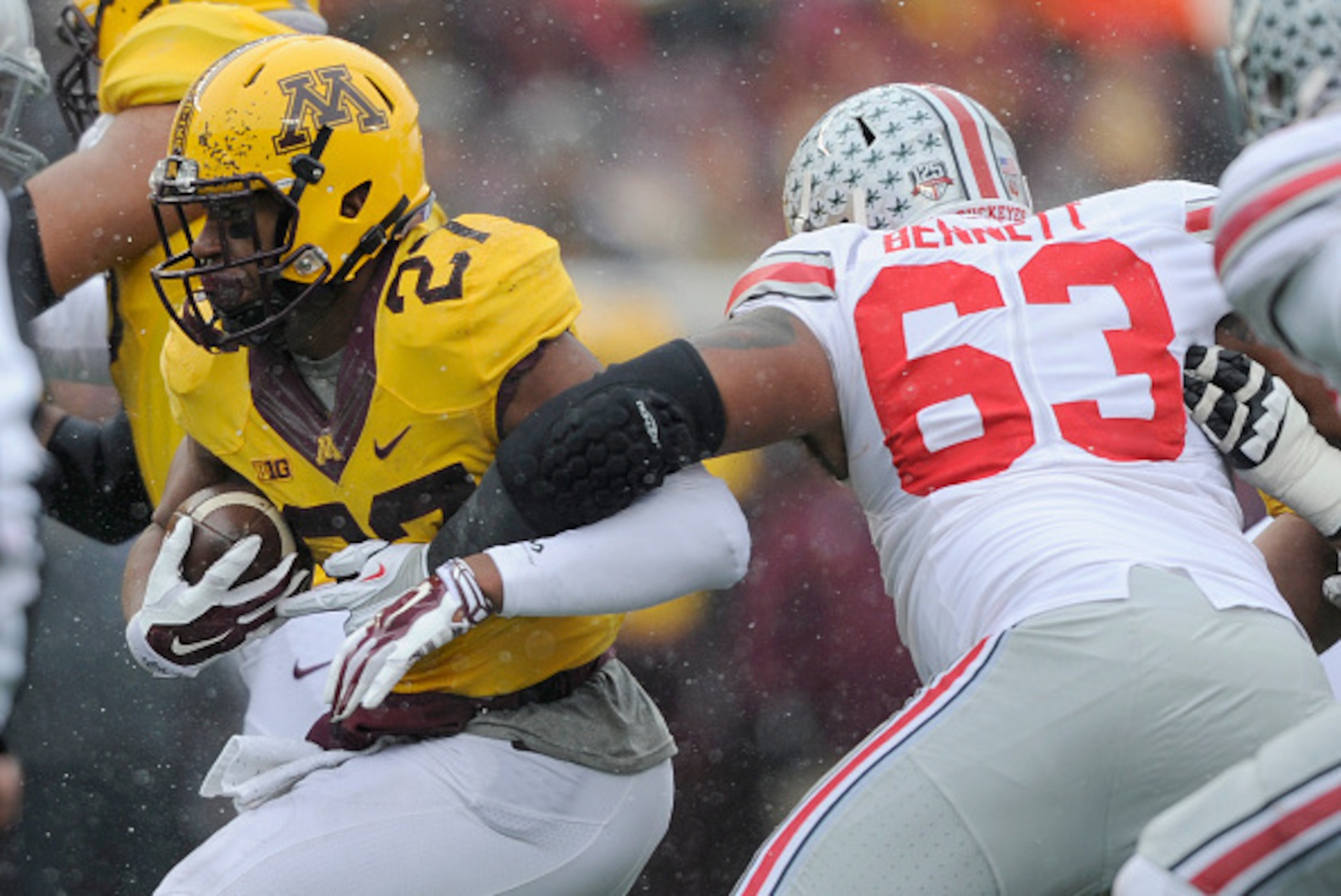 MINNEAPOLIS, MN - NOVEMBER 15: David Cobb #27 of the Minnesota Golden Gophers avoids a tackle by Michael Bennett #63 of the Ohio State Buckeyes during the second quarter of the game on November 15, 2014 at TCF Bank Stadium in Minneapolis, Minnesota. (Phot