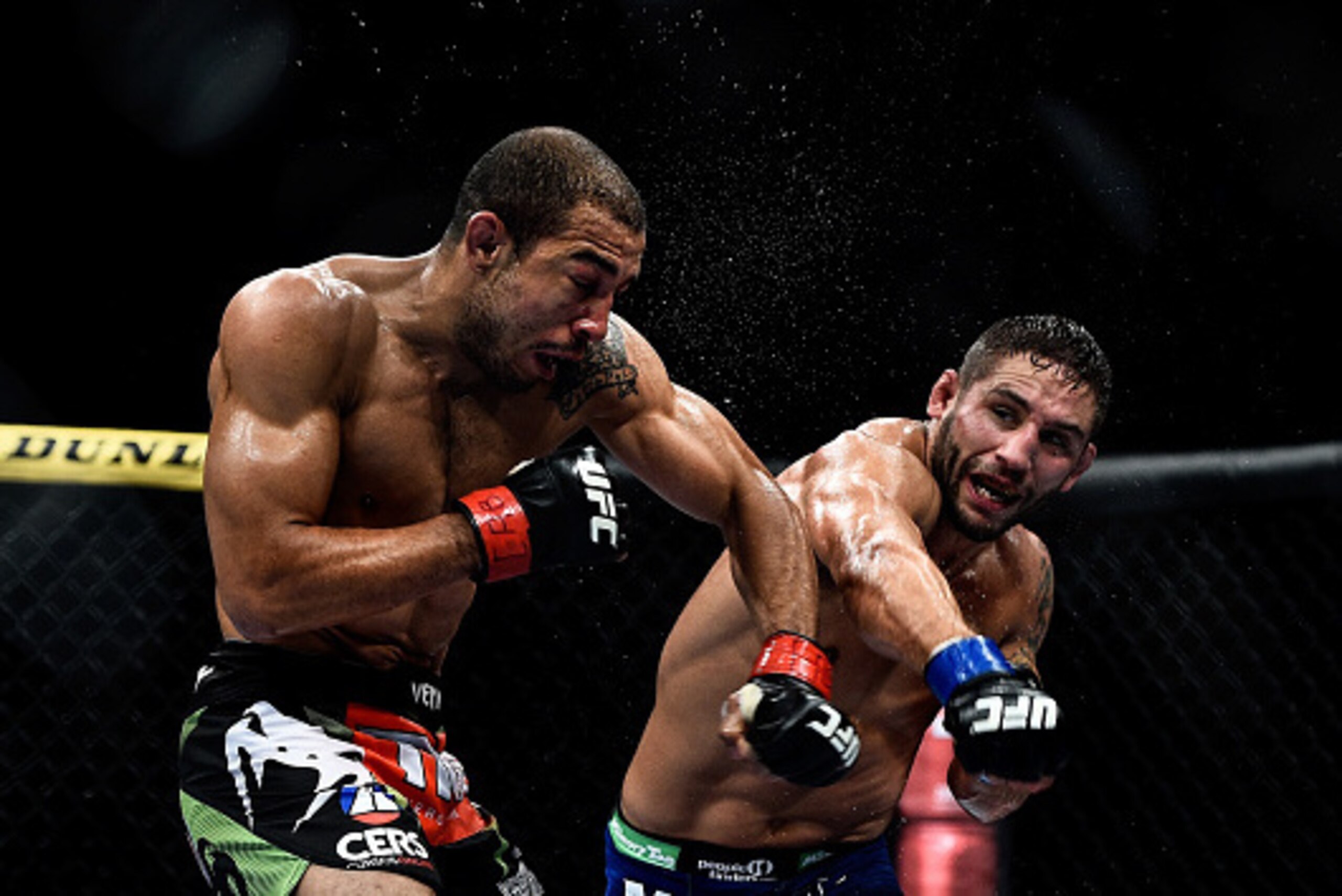 RIO DE JANEIRO, BRAZIL - OCTOBER 25: Chad Mendes of the United States punches Jose Aldo of Brazil in their featherweight championship bout during the UFC 179 event at Maracanazinho on October 25, 2014 in Rio de Janeiro, Brazil. (Photo by Buda Mendes/Getty