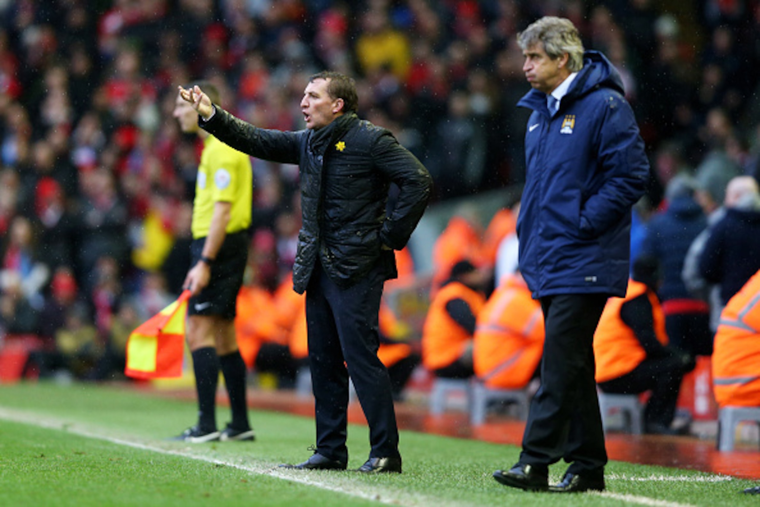 LIVERPOOL, ENGLAND - MARCH 01:  Brendan Rodgers the manager of Liverpool directs his players as Manuel Pellegrini the manager of Manchester City looks on during the Barclays Premier League match between Liverpool and Manchester City at Anfield on March 1,