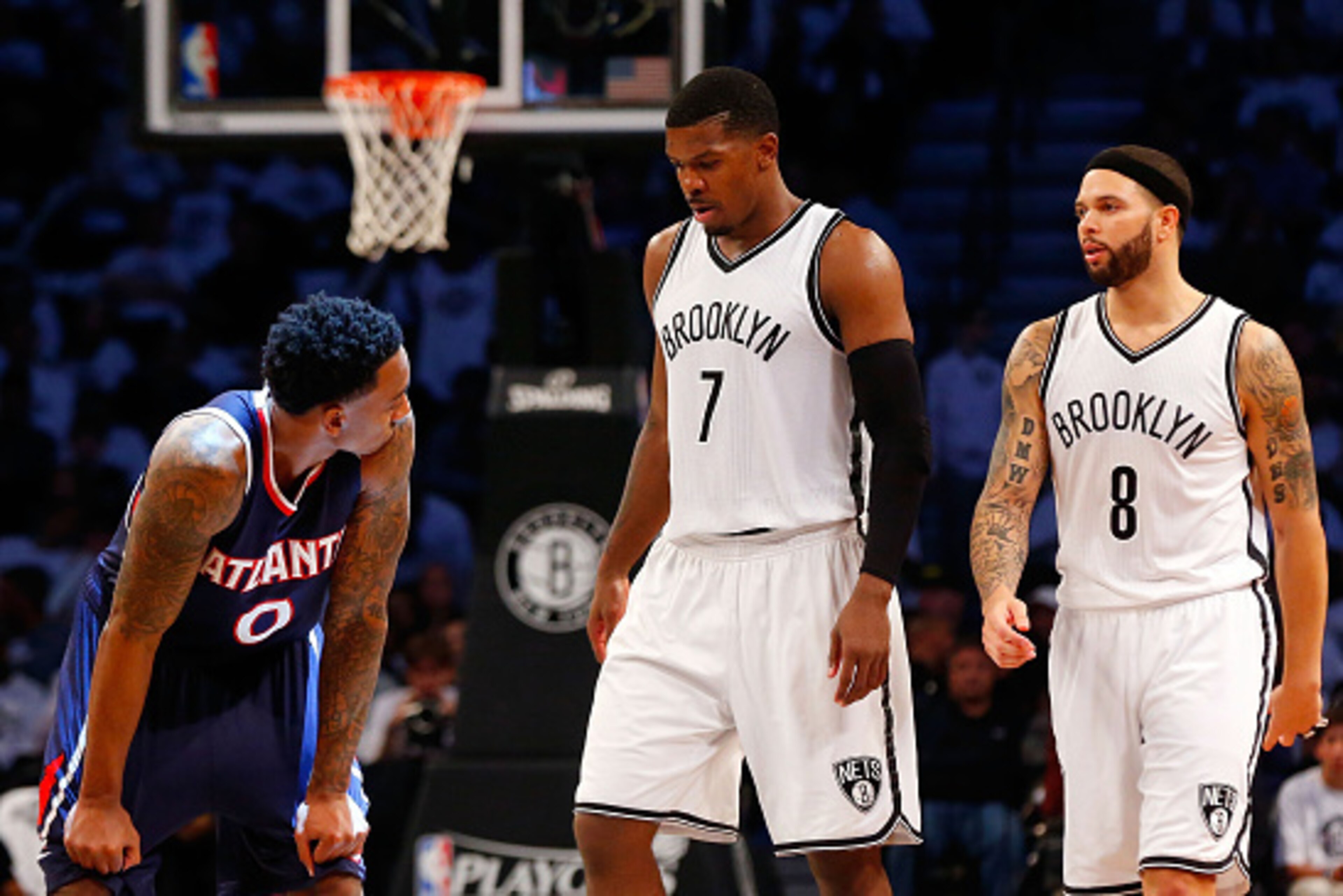 NEW YORK, NY - MAY 01:  Jeff Teague #0 of the Atlanta Hawks looks on as Joe Johnson #7 and Deron Williams #8 of the Brooklyn Nets walk on the court in the fourth quarter of game six in the first round of the 2015 NBA Playoffs at Barclays Center on May 1, 