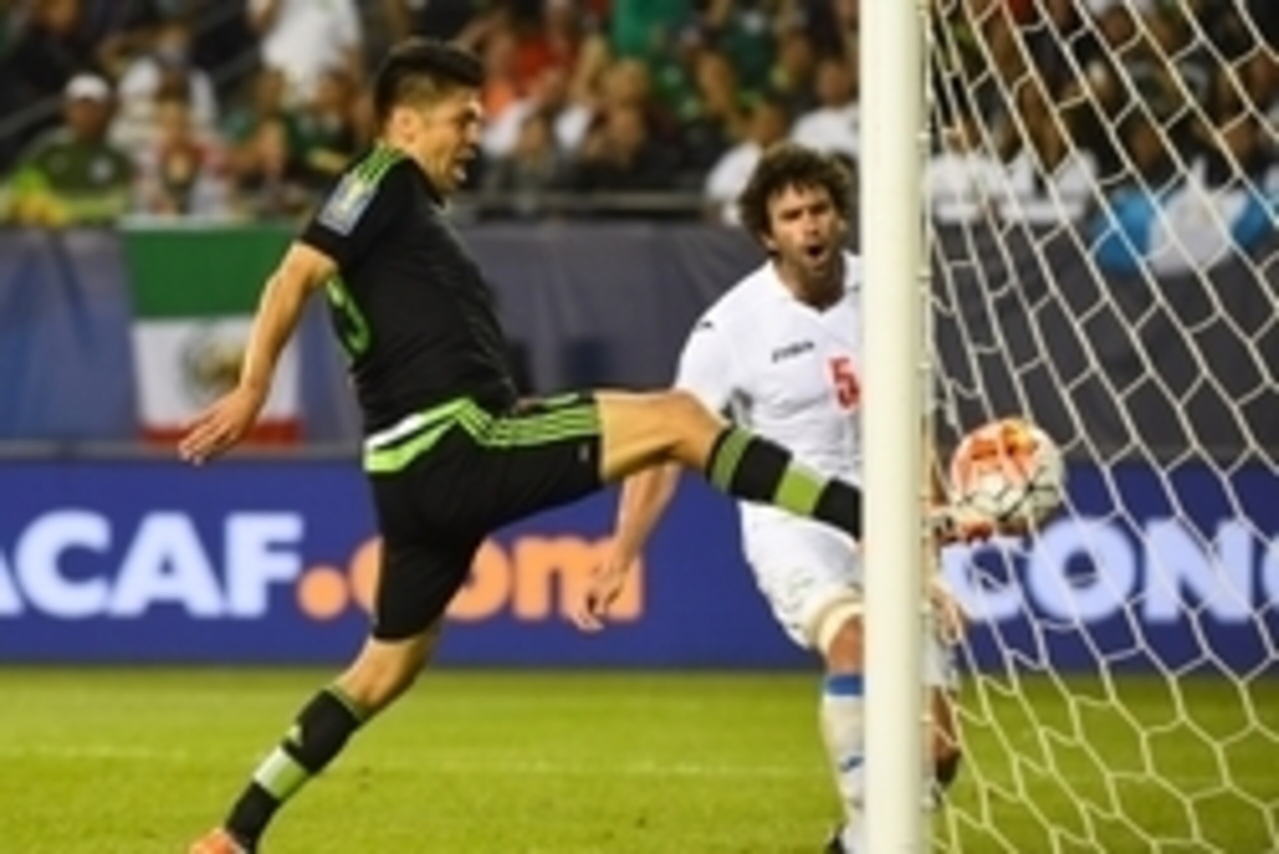 Jul 9, 2015; Chicago, IL, USA; Mexico forward Oribe Peralta (19) scores a goal against Cuba in the second half during CONCACAF Gold Cup group play at Soldier Field. Mexico defeats Cuba 6-0.  Mandatory Credit: Mike DiNovo-USA TODAY Sports