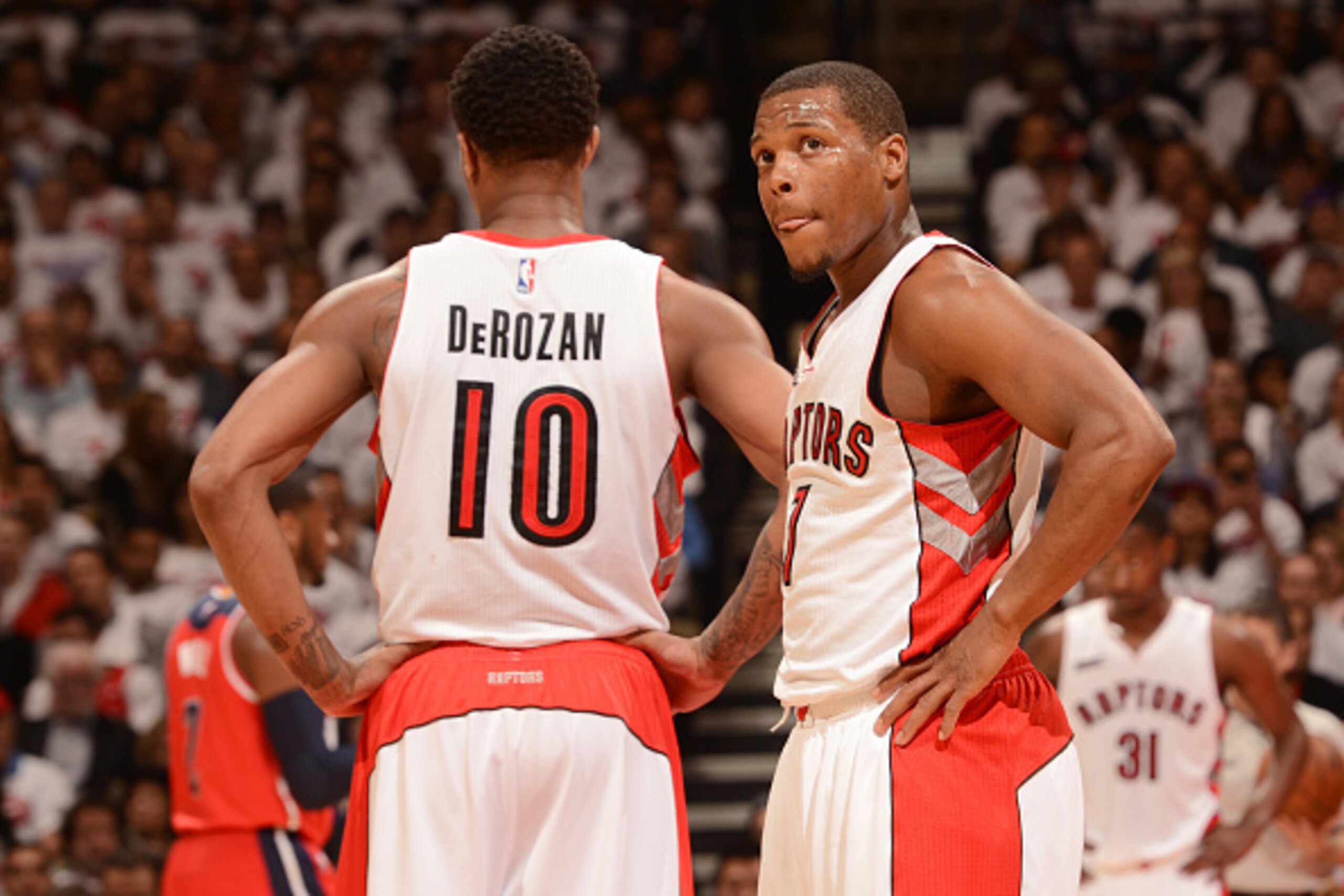 TORONTO, CANADA - April 21: DeMar DeRozan #10 and Kyle Lowry #7 of the Toronto Raptors speak during a game against the Washington Wizards during Game Two of the Eastern Conference Quarterfinals of the NBA Playoffs on April 21, 2015 at the Air Canada Centr TORONTO, CANADA - April 21: DeMar DeRozan #10 and Kyle Lowry #7 of the Toronto Raptors speak during a game against the Washington Wizards during Game Two of the Eastern Conference Quarterfinals of the NBA Playoffs on April 21, 2015 at the Air Canada Centr