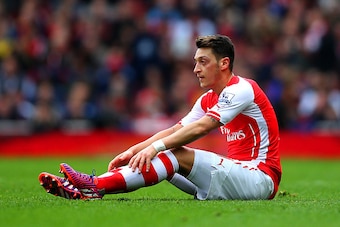 LONDON, ENGLAND - APRIL 04:  Mesut Oezil of Arsenal goes to ground during the Barclays Premier League match between Arsenal and Liverpool at Emirates Stadium on April 4, 2015 in London, England.  (Photo by Paul Gilham/Getty Images)