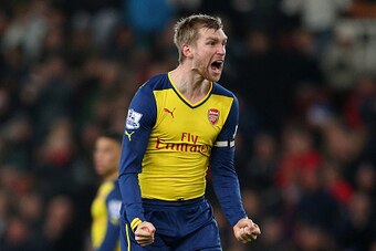 STOKE ON TRENT, ENGLAND - DECEMBER 06:  Per Mertesacker of Arsenal reacts after his team's second goal during the Barclays Premier League match between Stoke City and Arsenal  at the Britannia Stadium on December 6, 2014 in Stoke on Trent, England.  (Phot