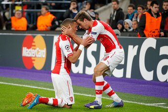 BRUSSELS, BELGIUM - OCTOBER 22:  Kieran Gibbs of Arsenal (L) celebrates with team mate Nacho Monreal as he scores their first and equalising goal during the UEFA Champions League Group D match between RSC Anderlecht and Arsenal at Constant Vanden Stock St