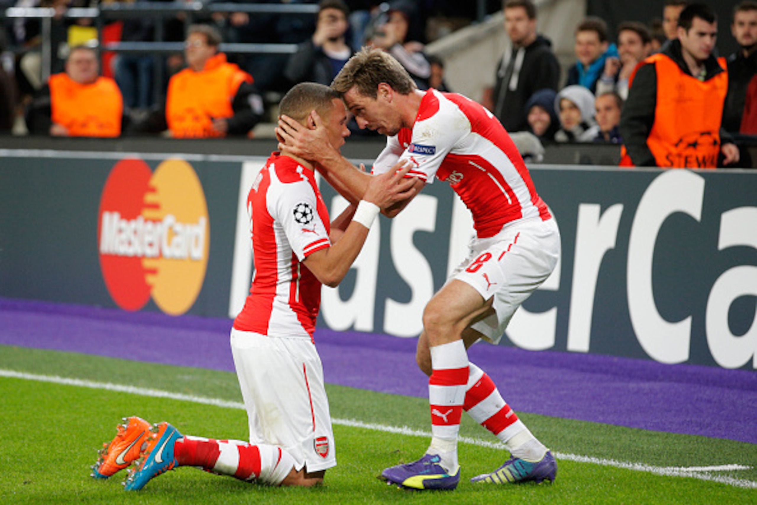 BRUSSELS, BELGIUM - OCTOBER 22:  Kieran Gibbs of Arsenal (L) celebrates with team mate Nacho Monreal as he scores their first and equalising goal during the UEFA Champions League Group D match between RSC Anderlecht and Arsenal at Constant Vanden Stock St