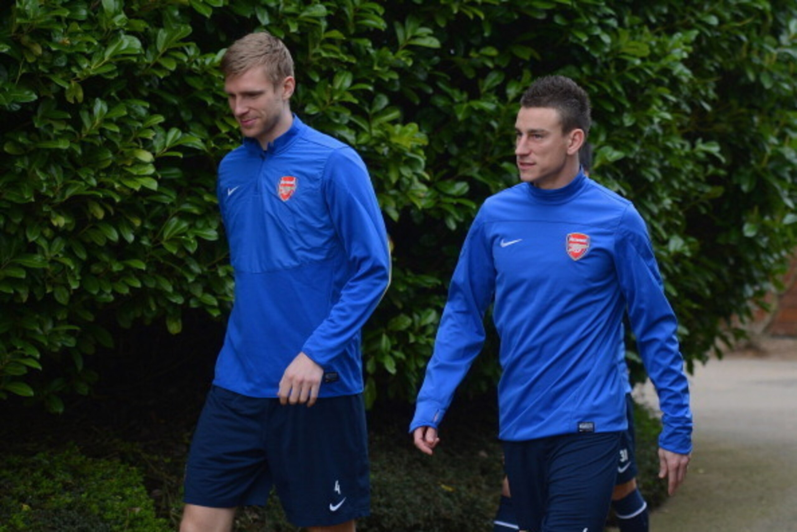ST ALBANS, ENGLAND - MARCH 10: Per Mertesacker and Laurent Koscielny look on during the Arsenal training session at London Colney on March 10, 2014 in St Albans, England.  (Photo by Michael Regan/Getty Images)