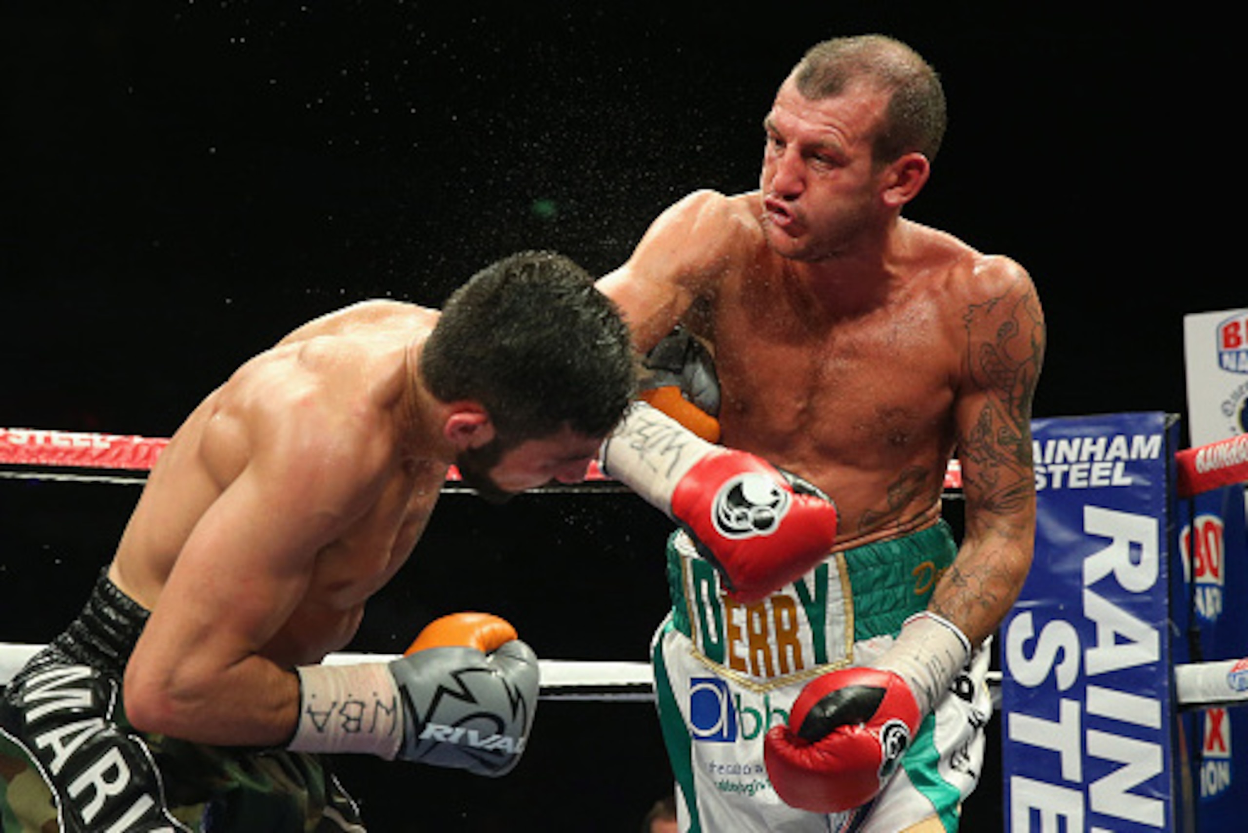 LIVERPOOL, ENGLAND - APRIL 18:  Derry Mathews throws a right punch at Tony Luis during The Vacant WBA Interim World Lightweight Championship fight between Derry Mathews and Tony Luis at the World Championship boxing event at Echo Arena on April 18, 2015 i