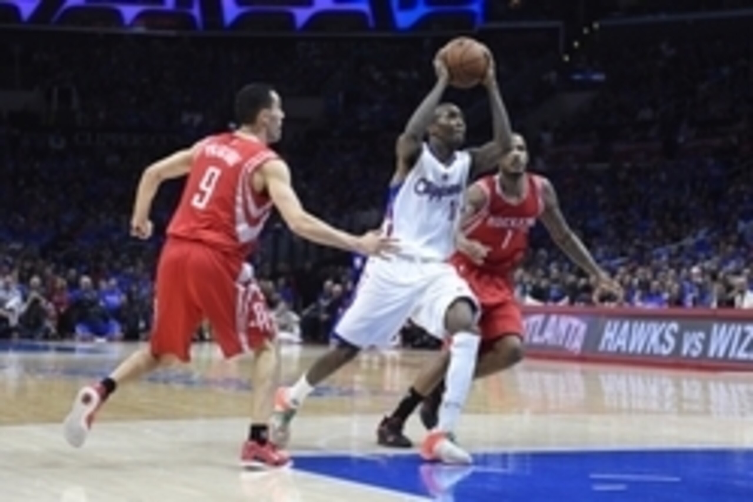 May 14, 2015; Los Angeles, CA, USA; Los Angeles Clippers guard Jamal Crawford (11) drives between Houston Rockets forward Terrence Jones (6) and Houston Rockets forward Trevor Ariza (1) in game six of the second round of the NBA Playoffs at Staples Center