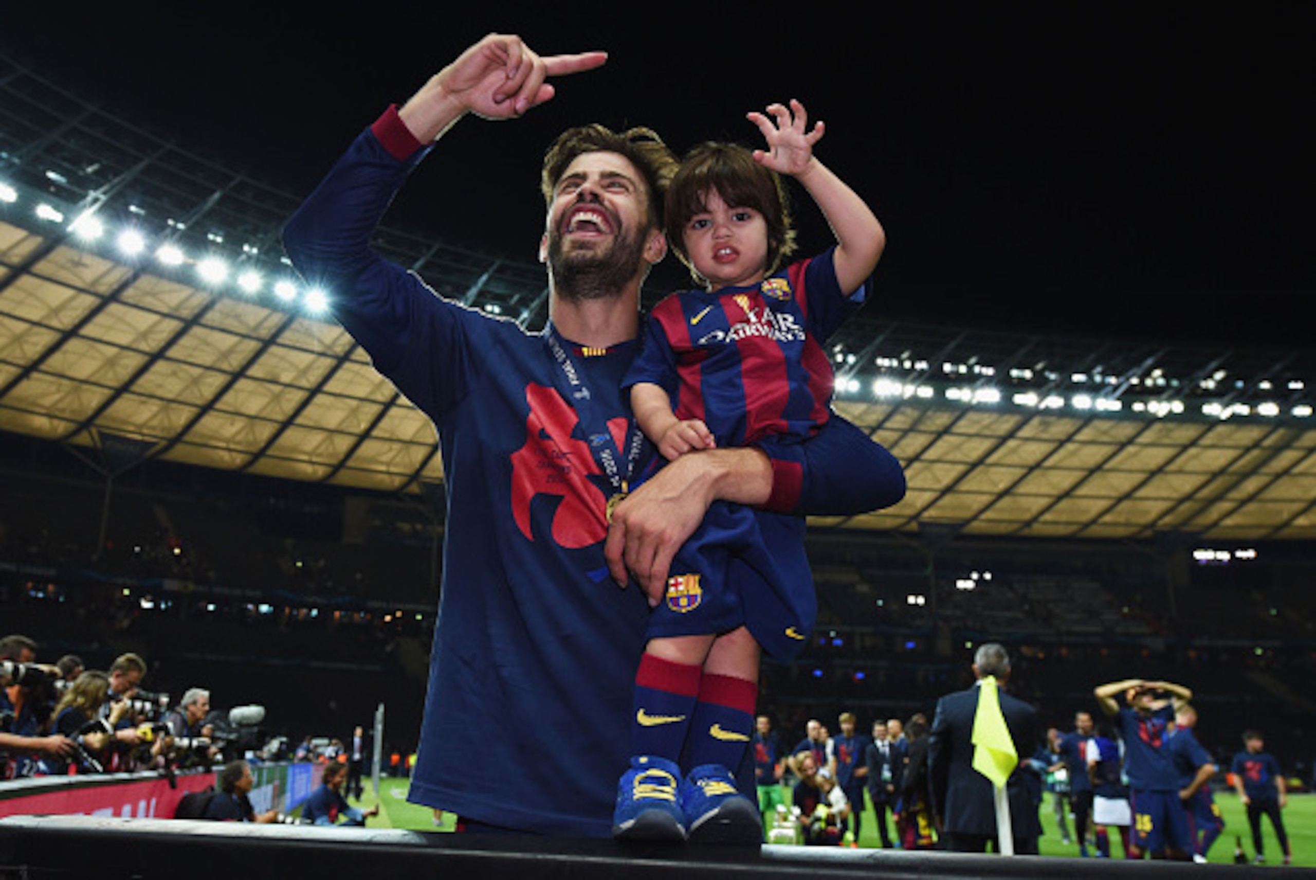 BERLIN, GERMANY - JUNE 06:  Gerard Pique of Barcelona celebrates with his son Milan after the UEFA Champions League Final between Juventus and FC Barcelona at Olympiastadion on June 6, 2015 in Berlin, Germany.  (Photo by Matthias Hangst/Getty Images)