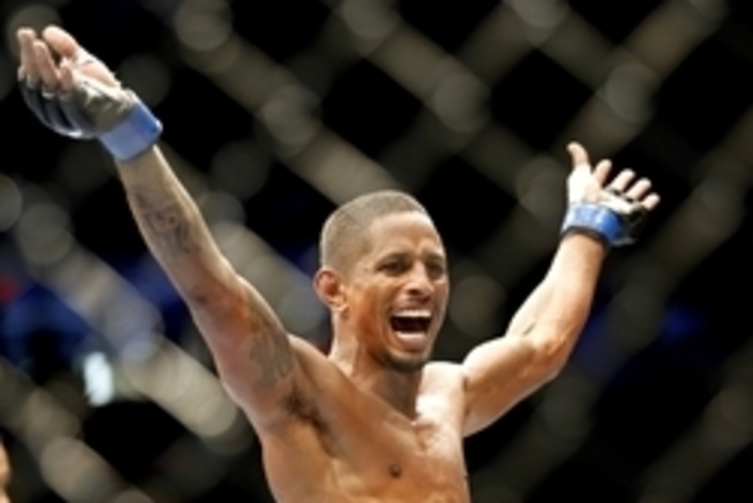 May 10, 2014; Cincinnati, OH, USA; Johnny Eduardo (blue gloves) celebrates after knocking out Eddie Wineland (not pictured) in the first round of a preliminary bantamweight bout at US Bank Arena. Mandatory Credit: Joe Maiorana-USA TODAY Sports