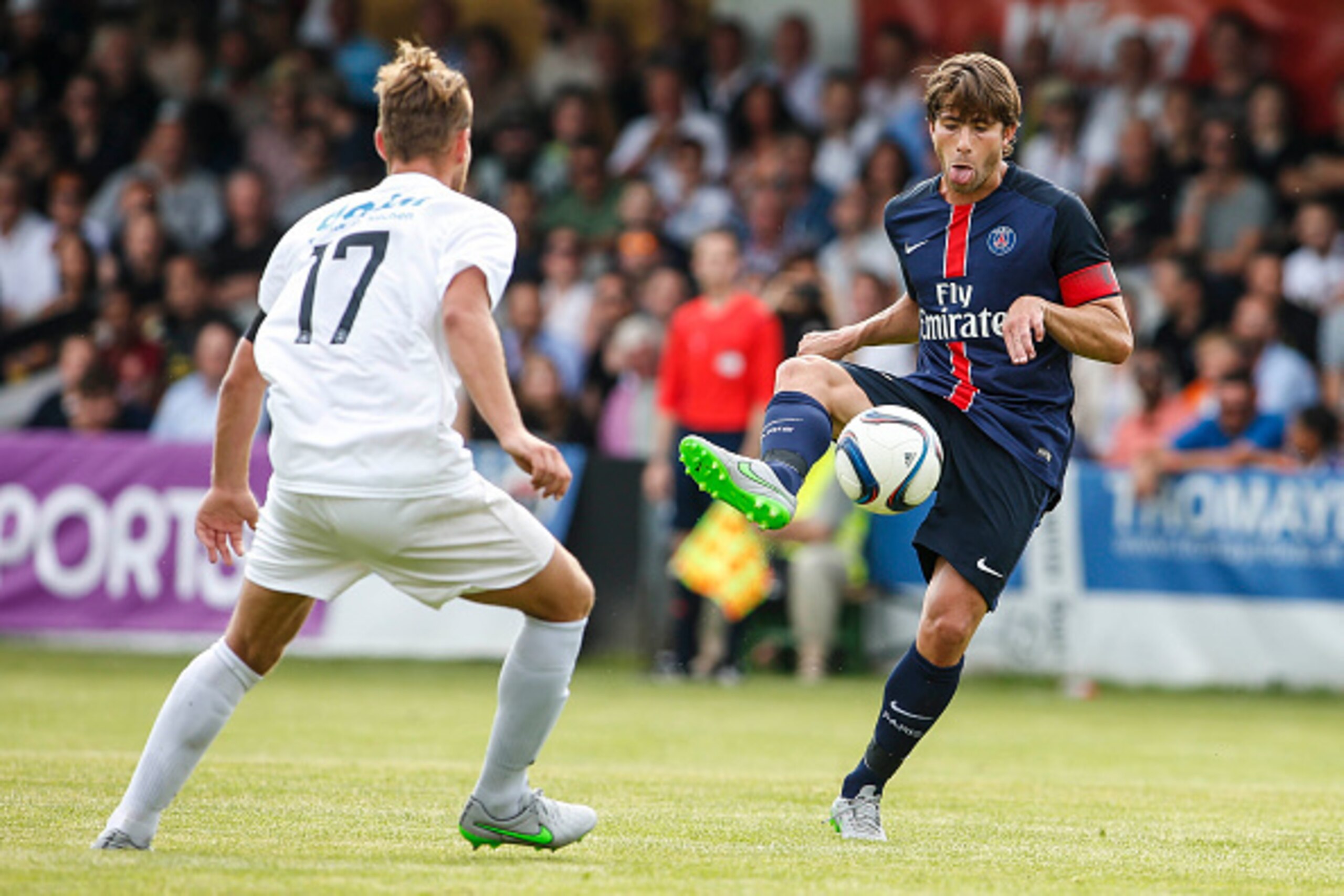 VIENNA, AUSTRIA - JULY 12:  Philip Dimov of Wiener Sportklub (L) competes for the ball with Maxwell Scherrer Cabelino Andrade of Paris Saint-Germain during the Friendly Match between Wiener Sportklub and Paris Saint-Germain at Sportclub Platz on July 12,