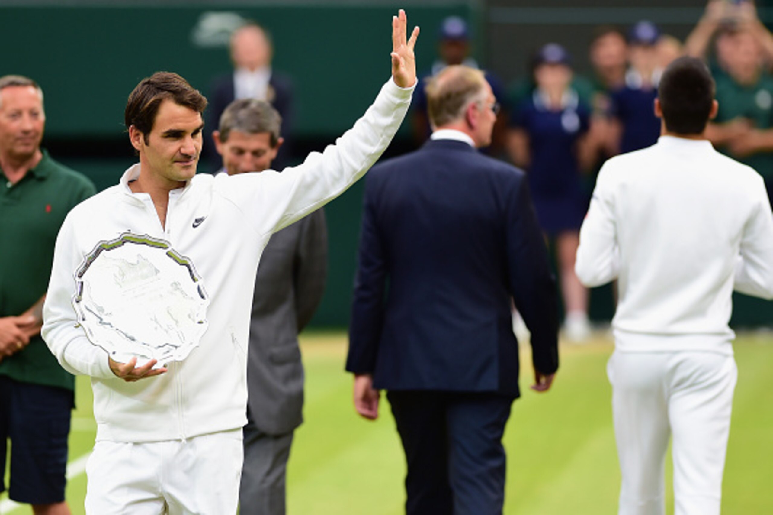 LONDON, ENGLAND - JULY 12: Roger Federer of Switzerland holds the runners up plate after losing in the final to Novak Djokovic of Serbia in the Final Of The Gentlemen's Singles on day thirteen of the Wimbledon Lawn Tennis Championships at the All England LONDON, ENGLAND - JULY 12: Roger Federer of Switzerland holds the runners up plate after losing in the final to Novak Djokovic of Serbia in the Final Of The Gentlemen's Singles on day thirteen of the Wimbledon Lawn Tennis Championships at the All England