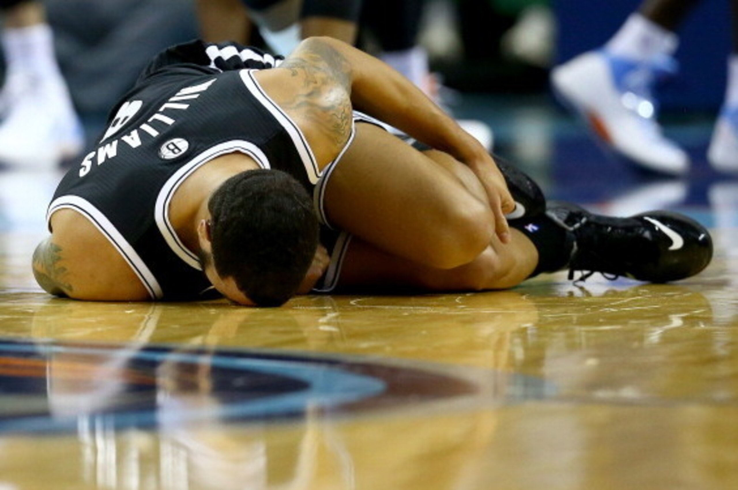 CHARLOTTE, NC - NOVEMBER 20:  Deron Williams #8 of the Brooklyn Nets reacts after an injury in the first half during their game against the Charlotte Bobcats at Time Warner Cable Arena on November 20, 2013 in Charlotte, North Carolina.  NOTE TO USER: User