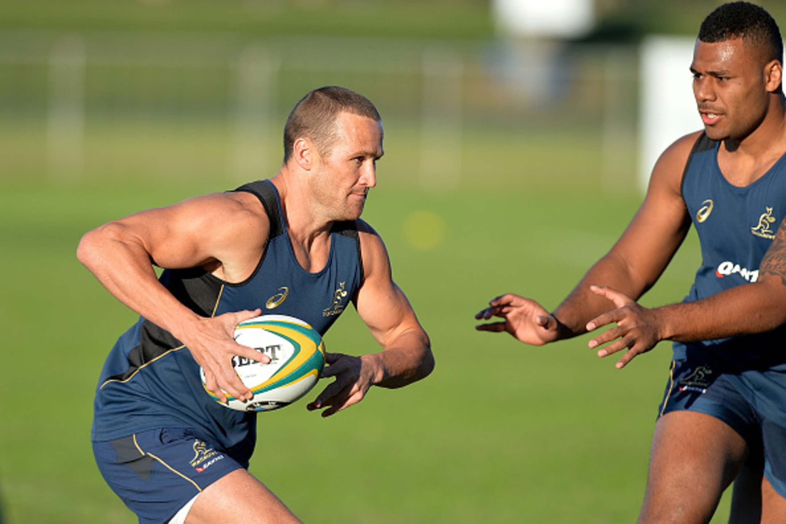 SUNSHINE COAST, AUSTRALIA - JULY 06:  Matt Giteau takes on the defence during an Australian Wallabies training session at Sunshine Coast Stadium on July 6, 2015 on the Sunshine Coast, Australia.  (Photo by Bradley Kanaris/Getty Images)